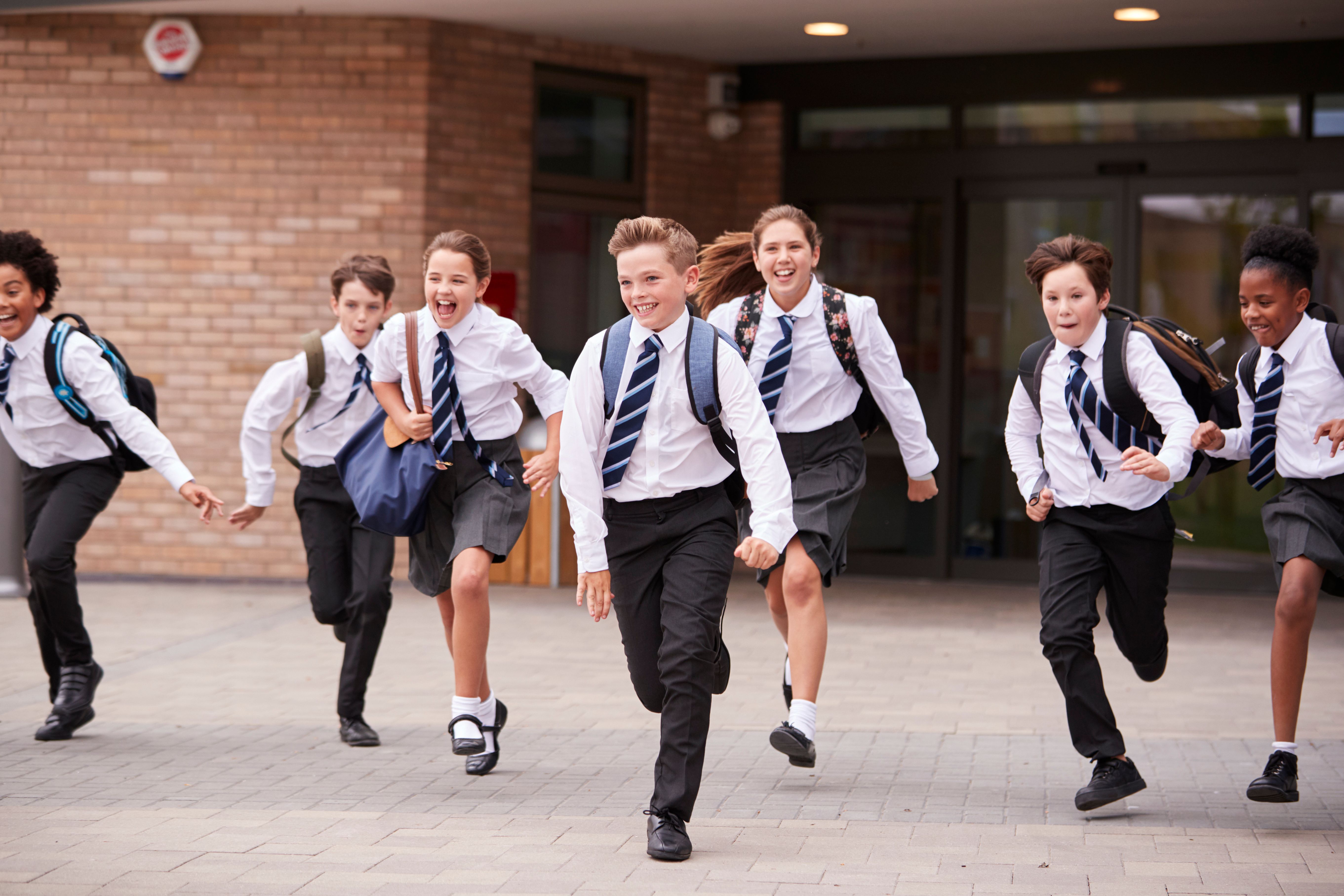 Students running outside school. | Source: Shutterstock