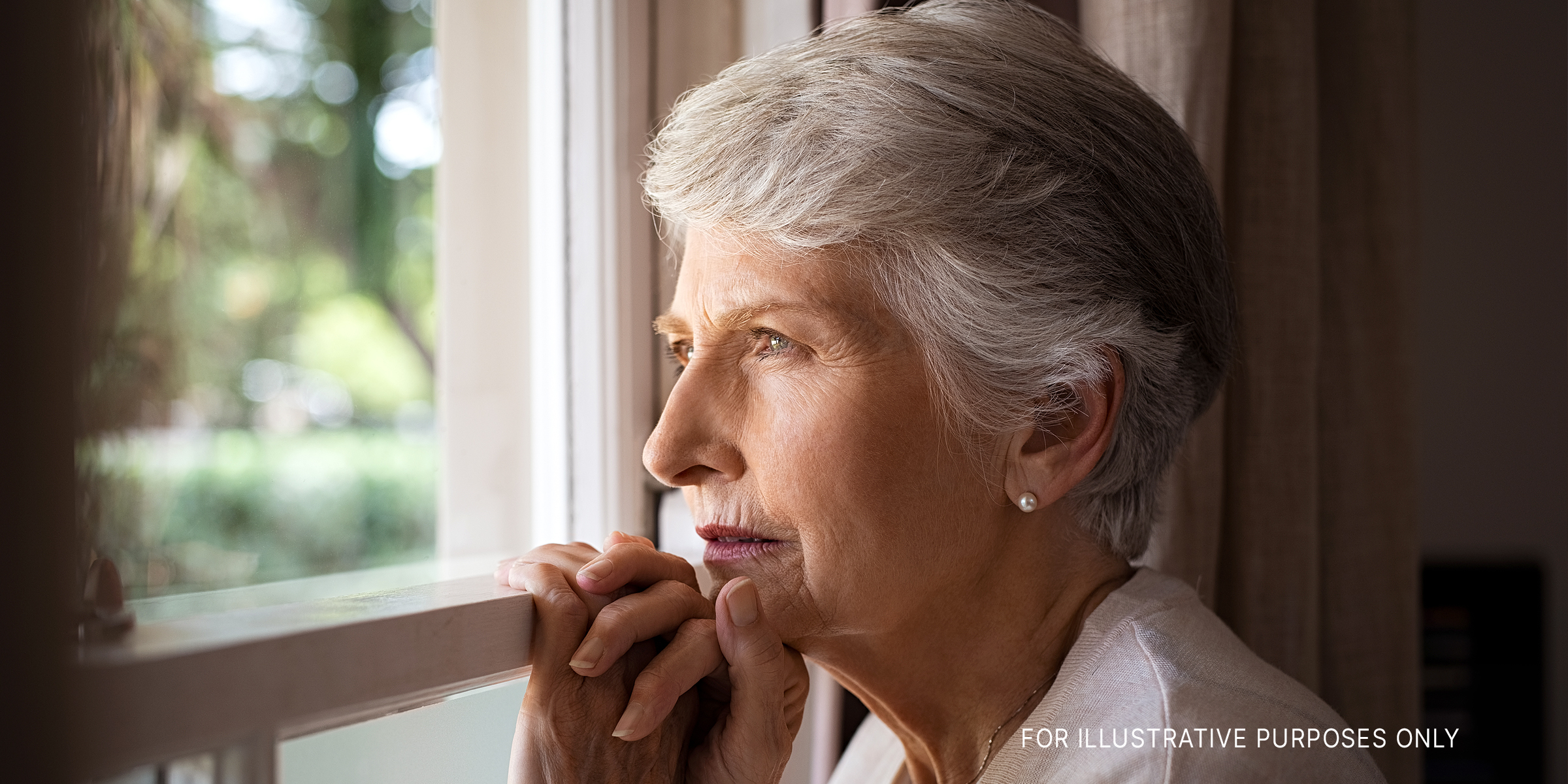 Senior woman looking out a window | Source: Getty Images