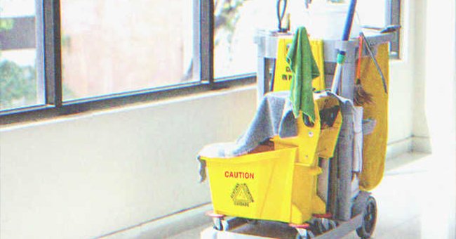 A cart of cleaning supplies beside a window | Photo: Shutterstock