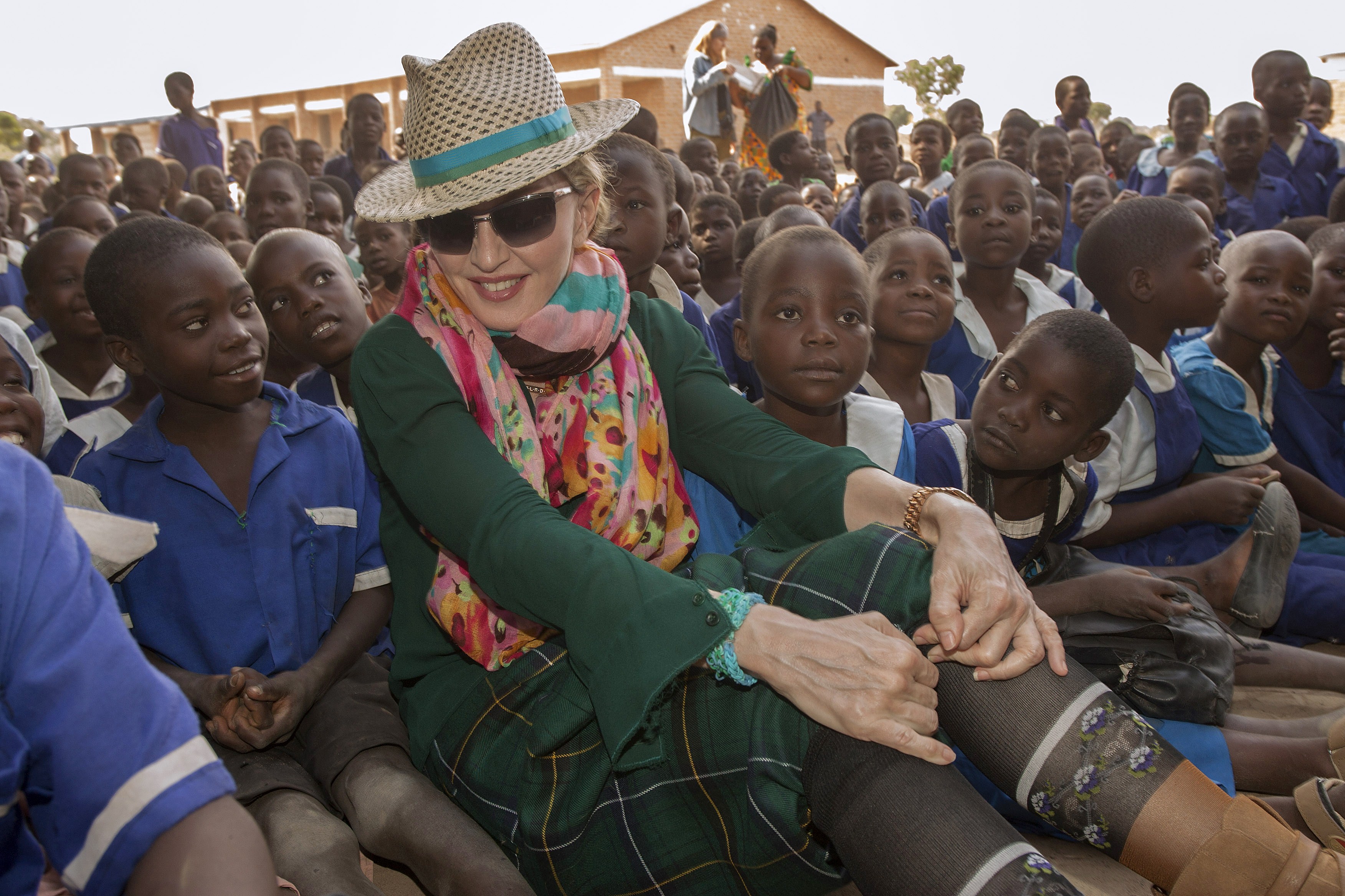 Madonna surrounded by children during her visit to Mkoko Primary School in the Kasungu District, Central Malawi on November 30, 2014 | Source: Getty Images