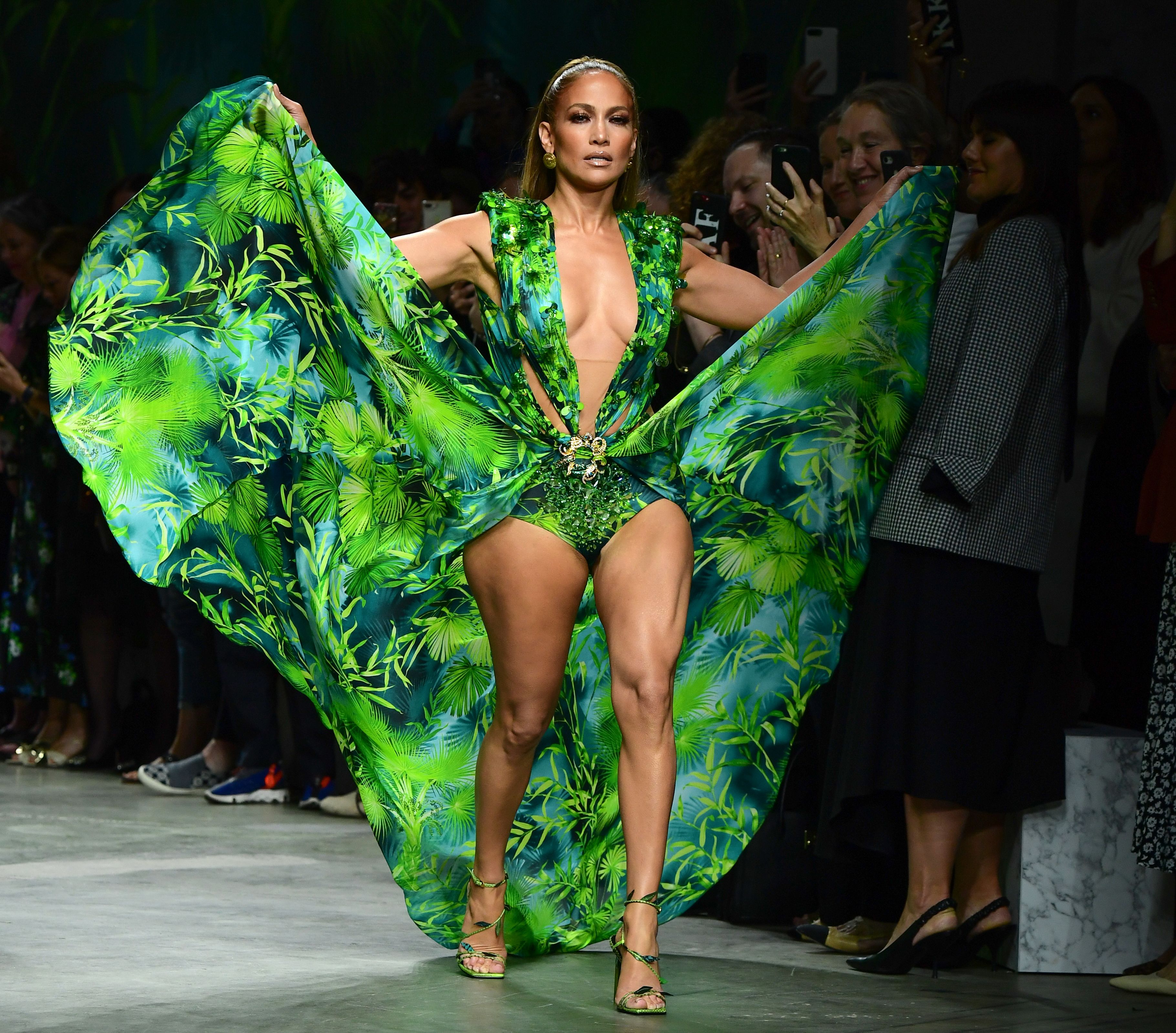 Jennifer Lopez walking the runway in a green Versace dress in Milan, Italy on September 20, 2019 | Source: Getty Images