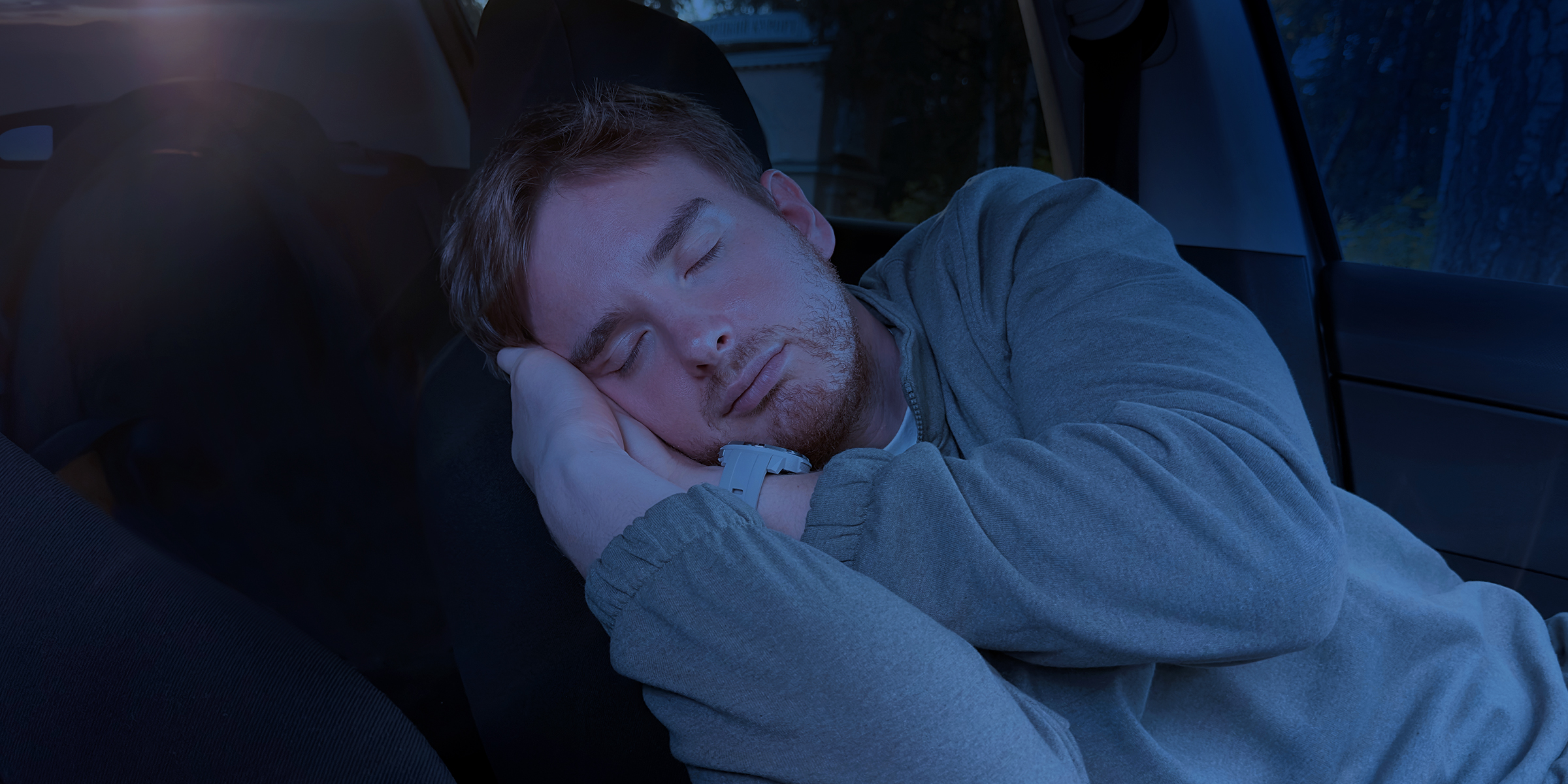 A man sleeping in his car | Source: Shutterstock