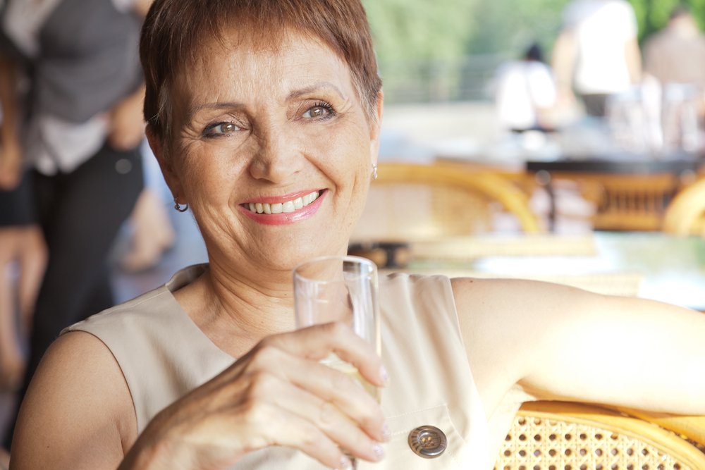 A senior woman with a glass of drink. | Photo: Shutterstock