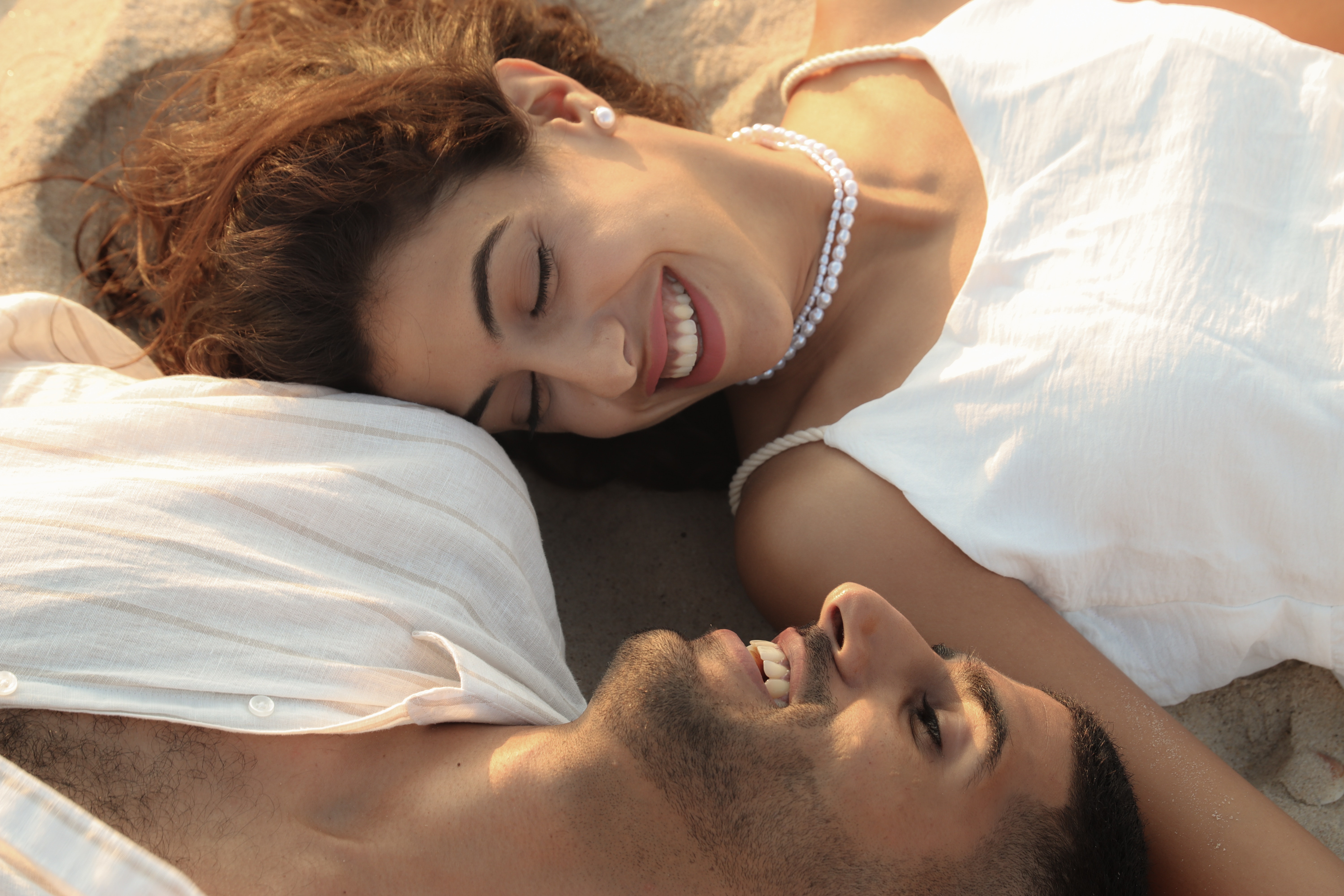 Smiling Couple Lying Down Together. | Source: Pexels