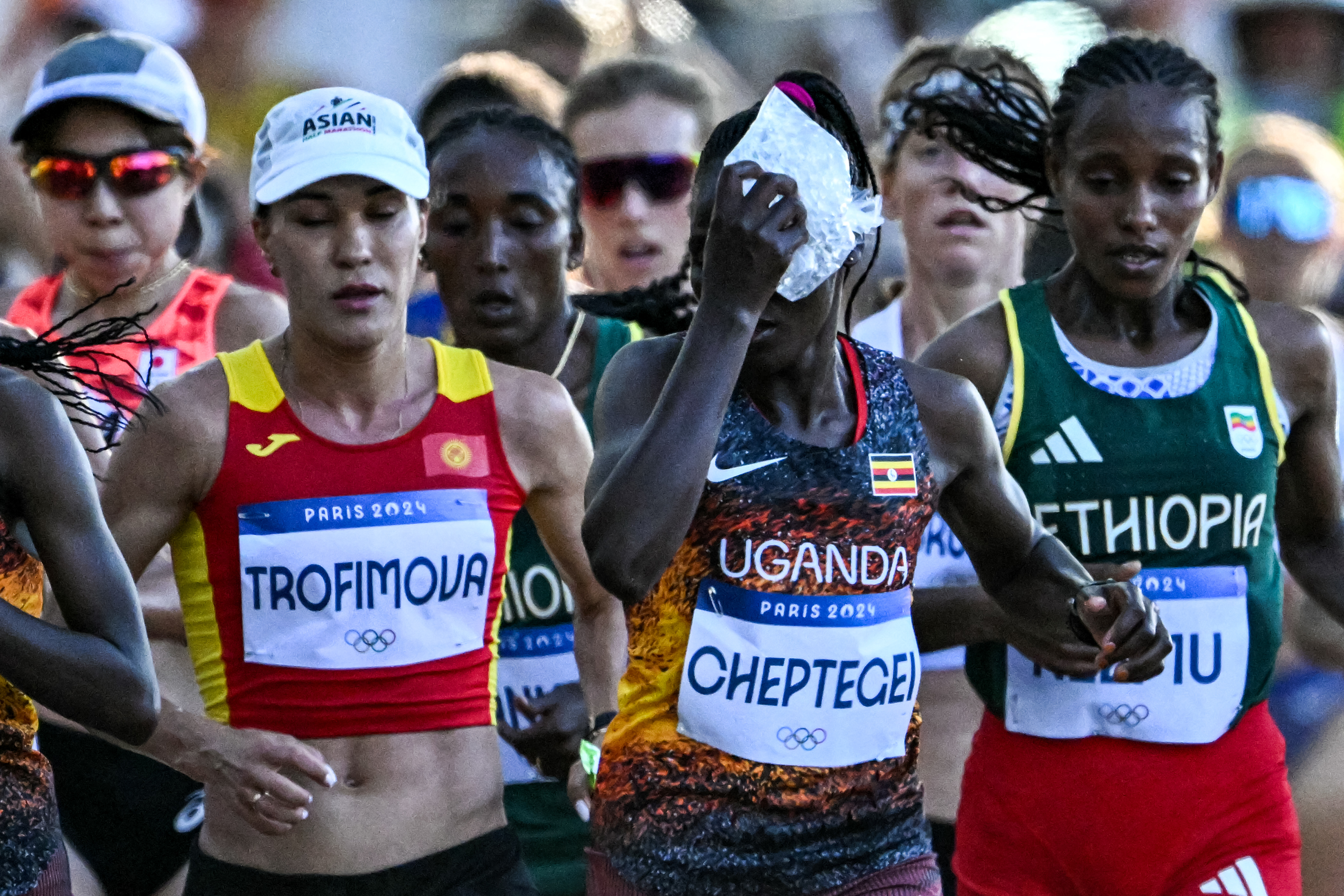 Rebecca Cheptegei holding an ice bag to her head while competing in the Women's Marathon of the Athletics event at the Paris 2024 Olympic Games in France on August 11, 2024. | Source: Getty Images