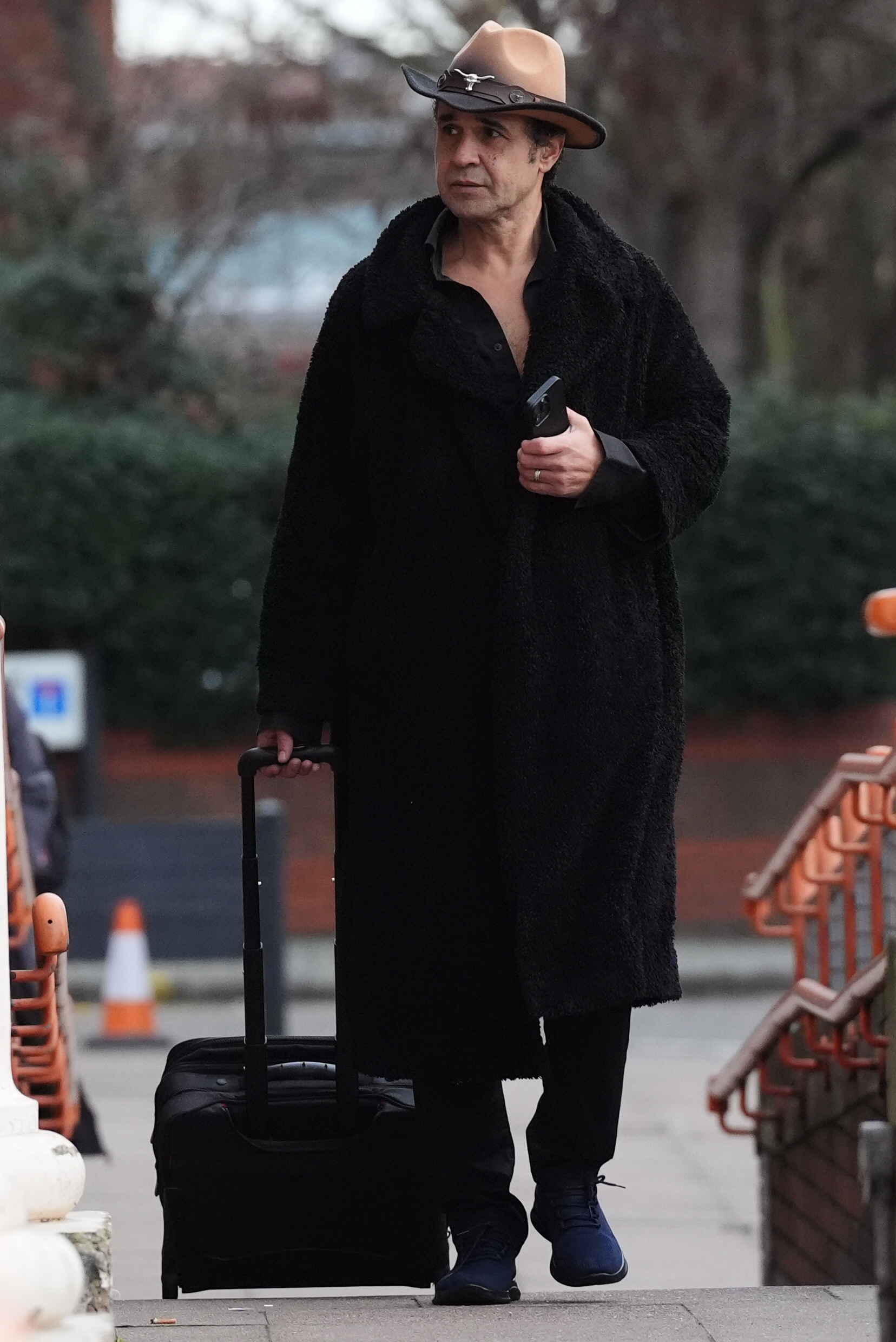 Yousseph "Chico" Slimani paused while pulling a suitcase as he arrived at Willesden Magistrates' Court in north London, England, on 30 December 2025, in connection with a drink-driving offence on 13 December 2025. | Source: Getty Images