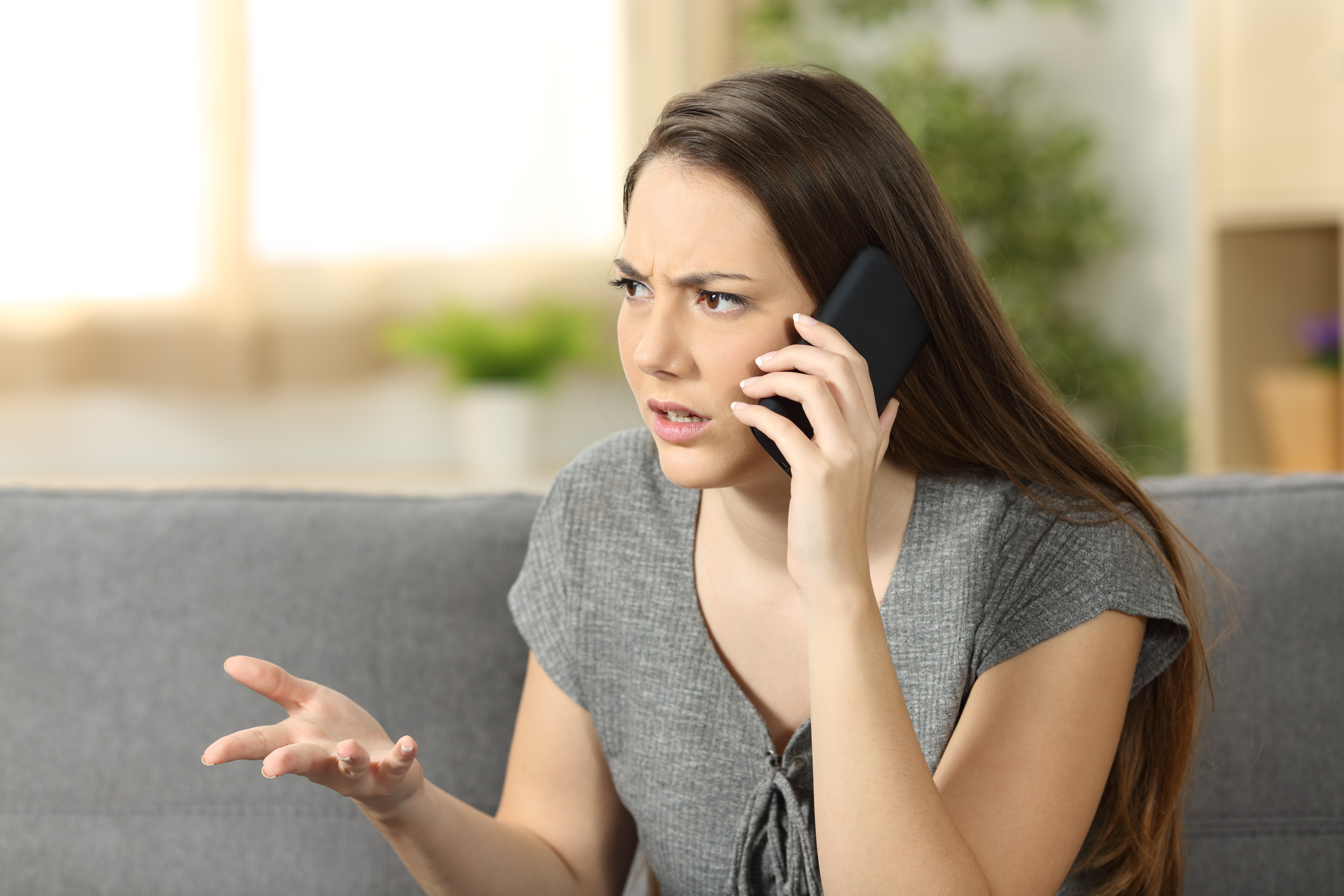 A woman talking on a phone call | Source: Shutterstock