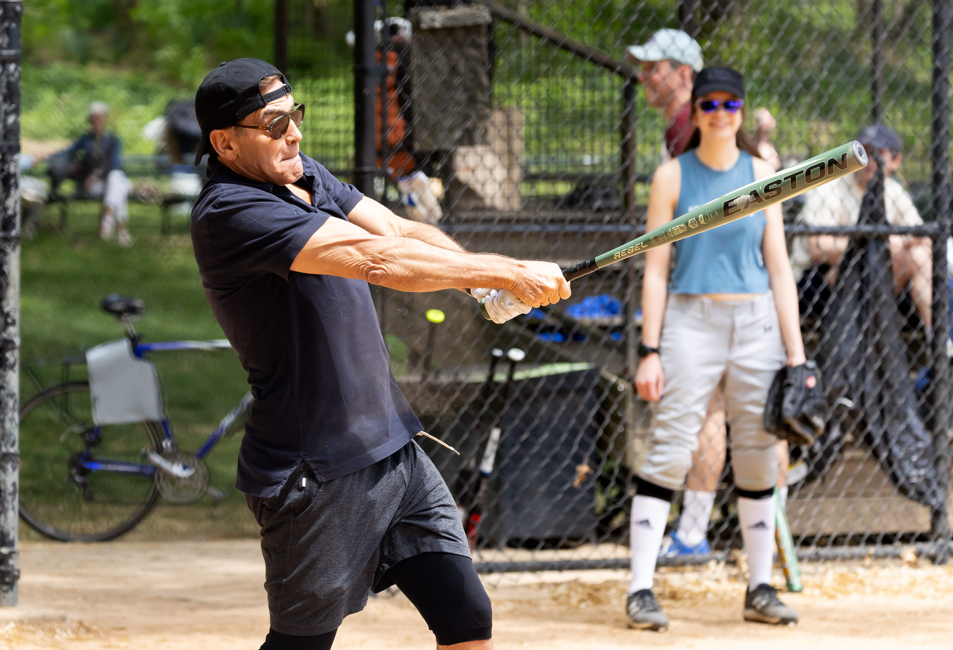 Clooney swings with full force, his focus locked in as the bat slices through the air. The intensity on his face says it all—he’s in it to win it.