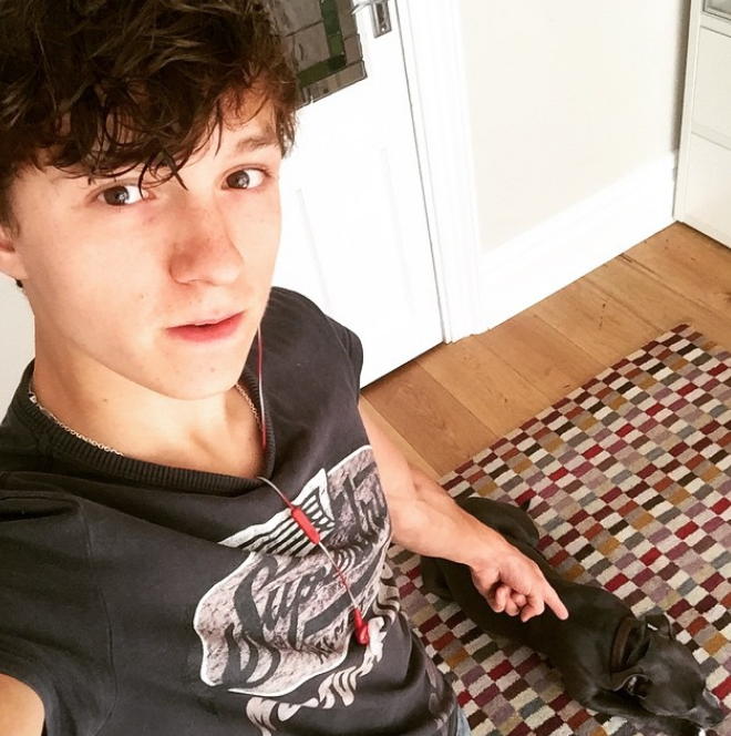 It was only a matter of time before Hollywood came calling for the rising star. In this photo, he posed at home with his dog on June 25, 2015. | Source: Instagram/tomholland2013