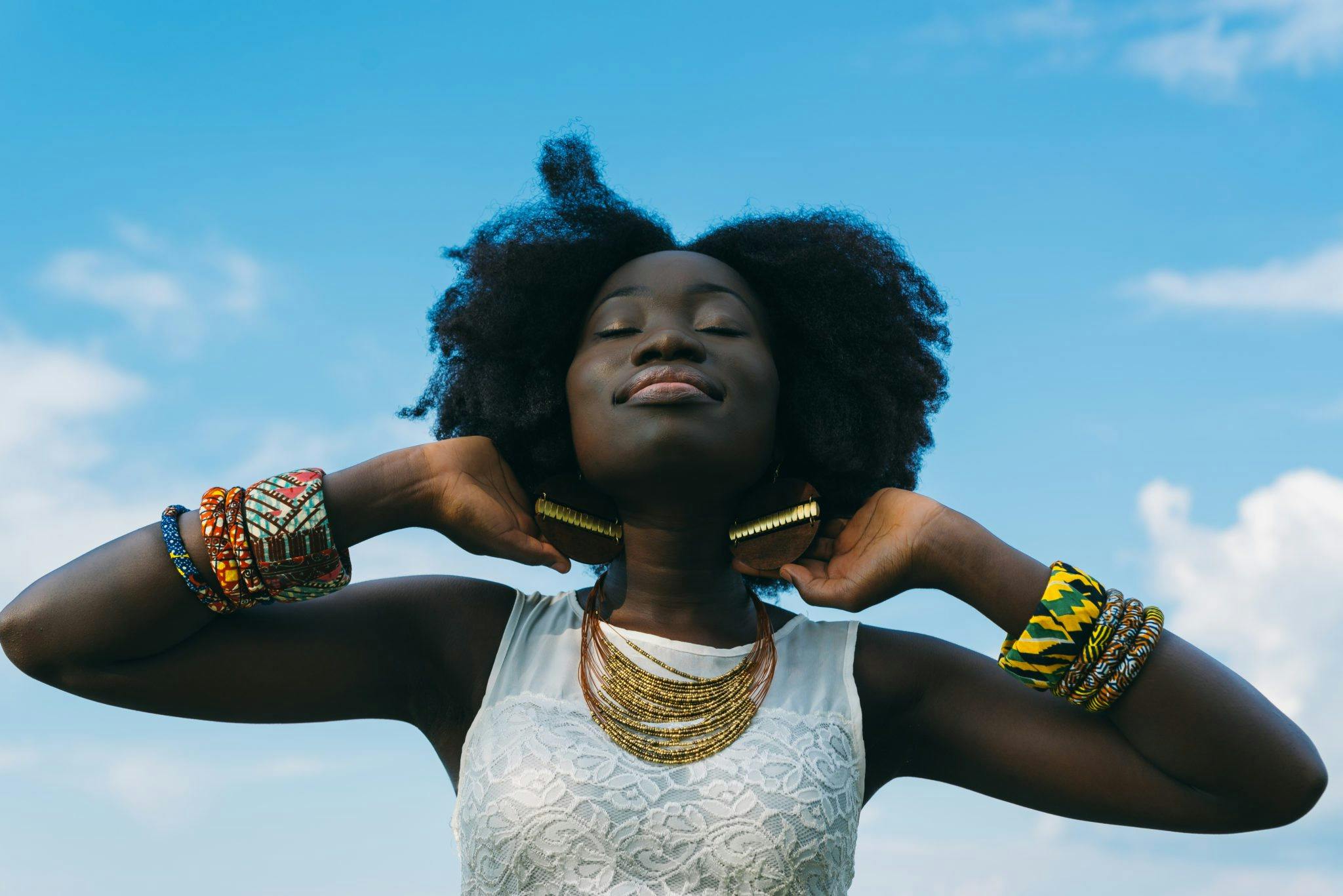 For illustration purposes only. A woman embraces her natural hair | Source: Pexels