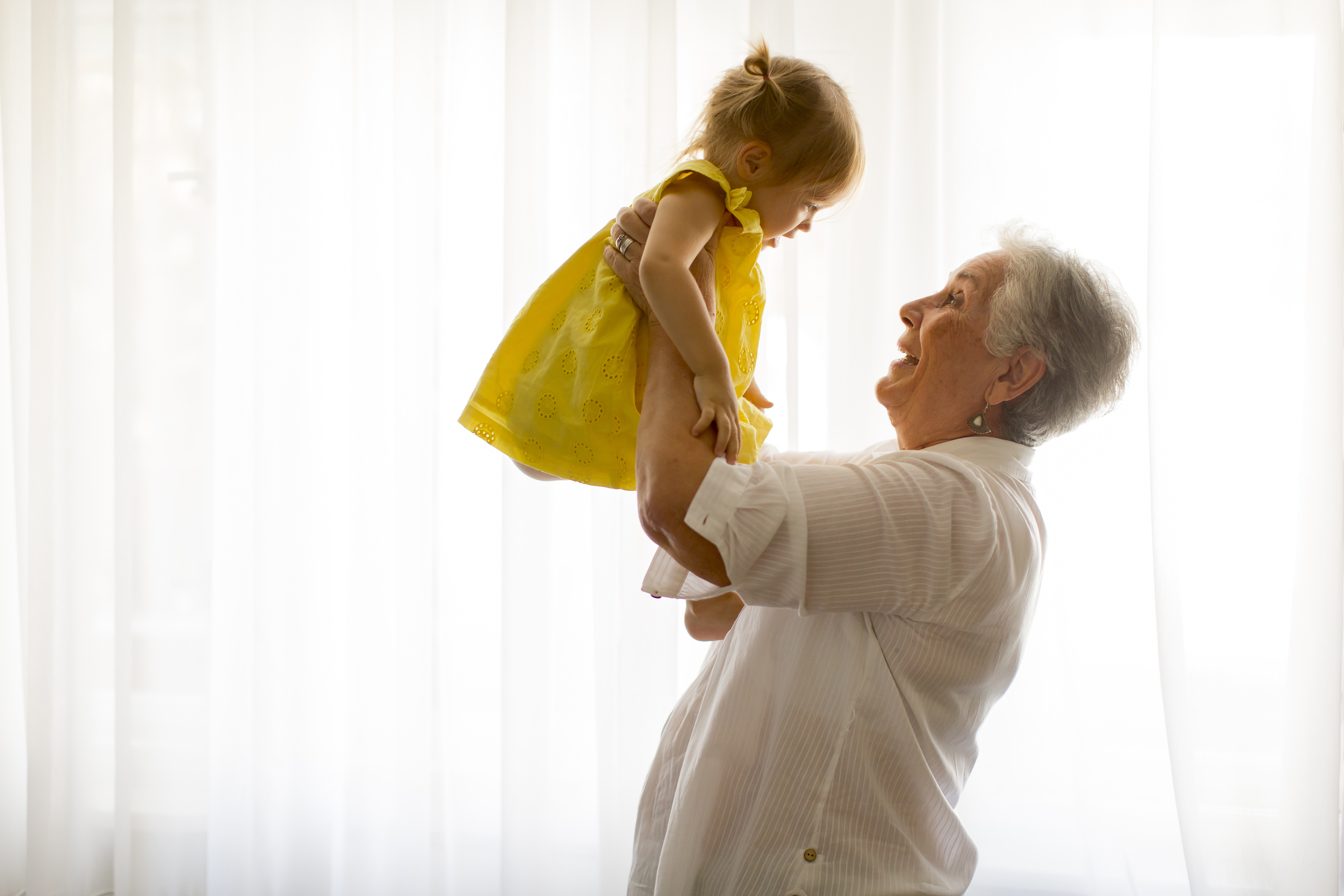 A grandmother holding her granddaughter | Source: Shutterstock