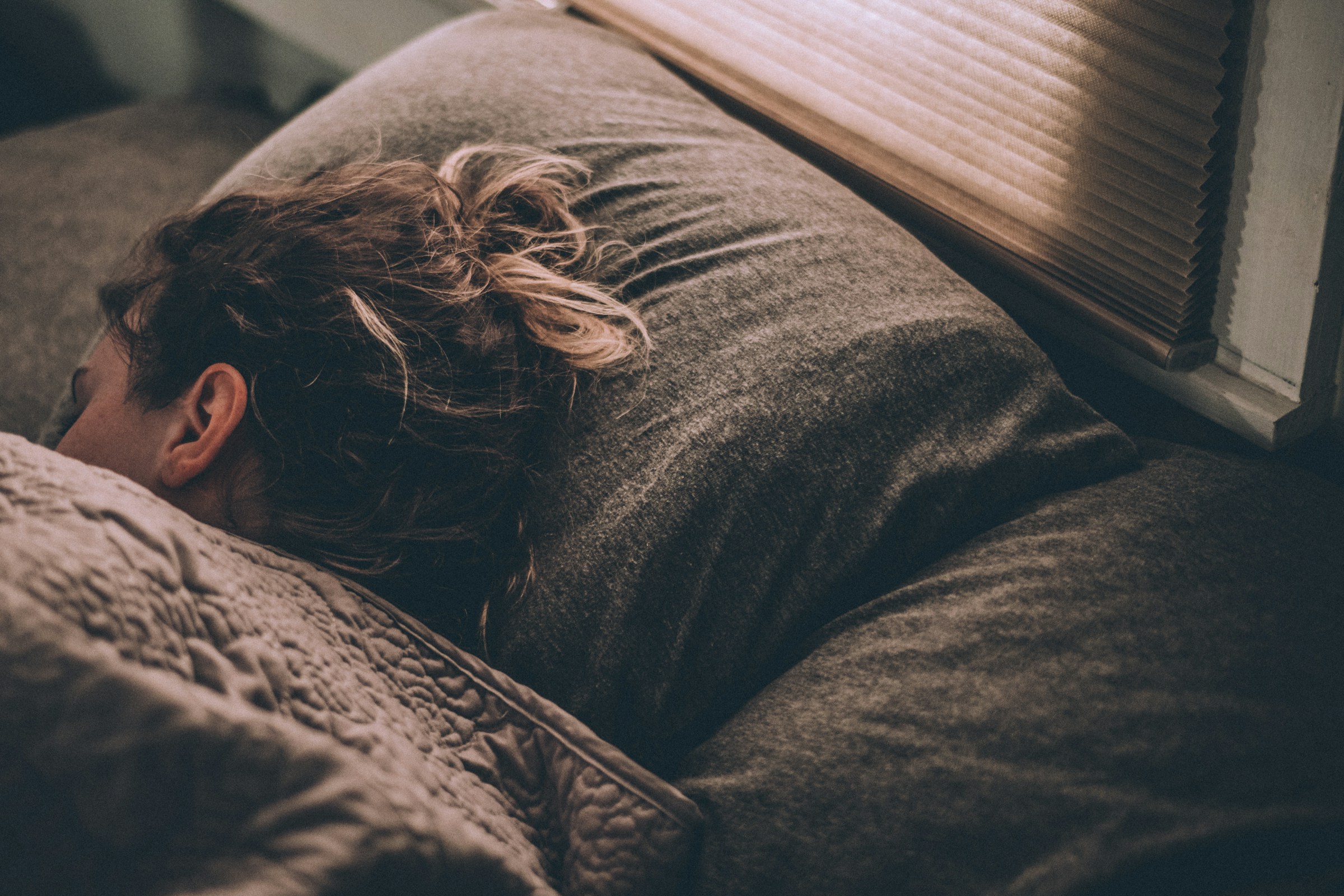 A woman lying down in bed | Source: Unsplash