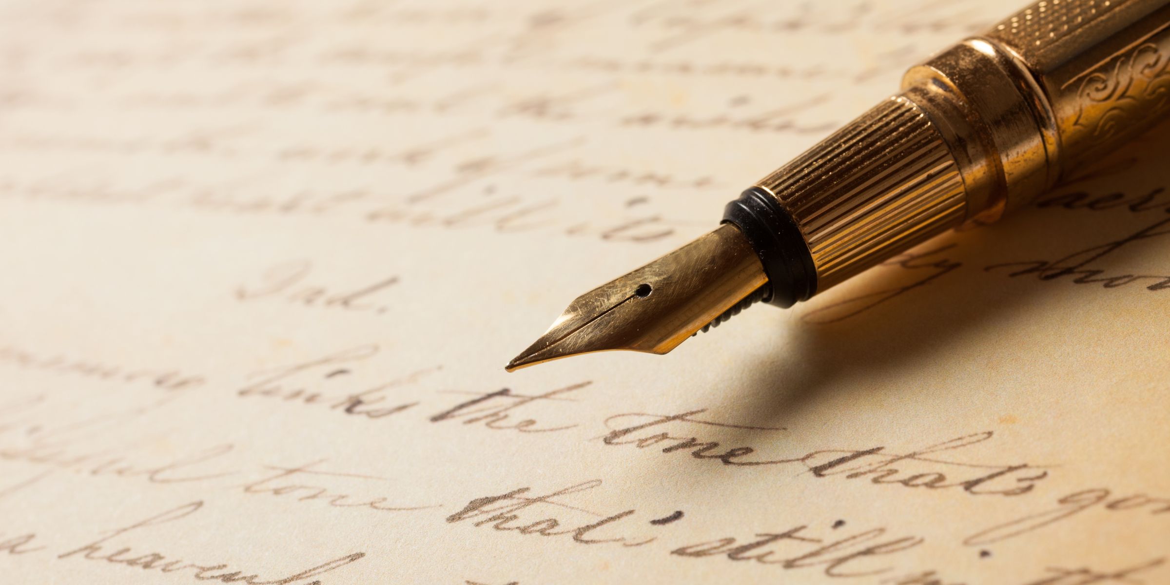 An engraved fountain pen on written paper | Source: Shutterstock
