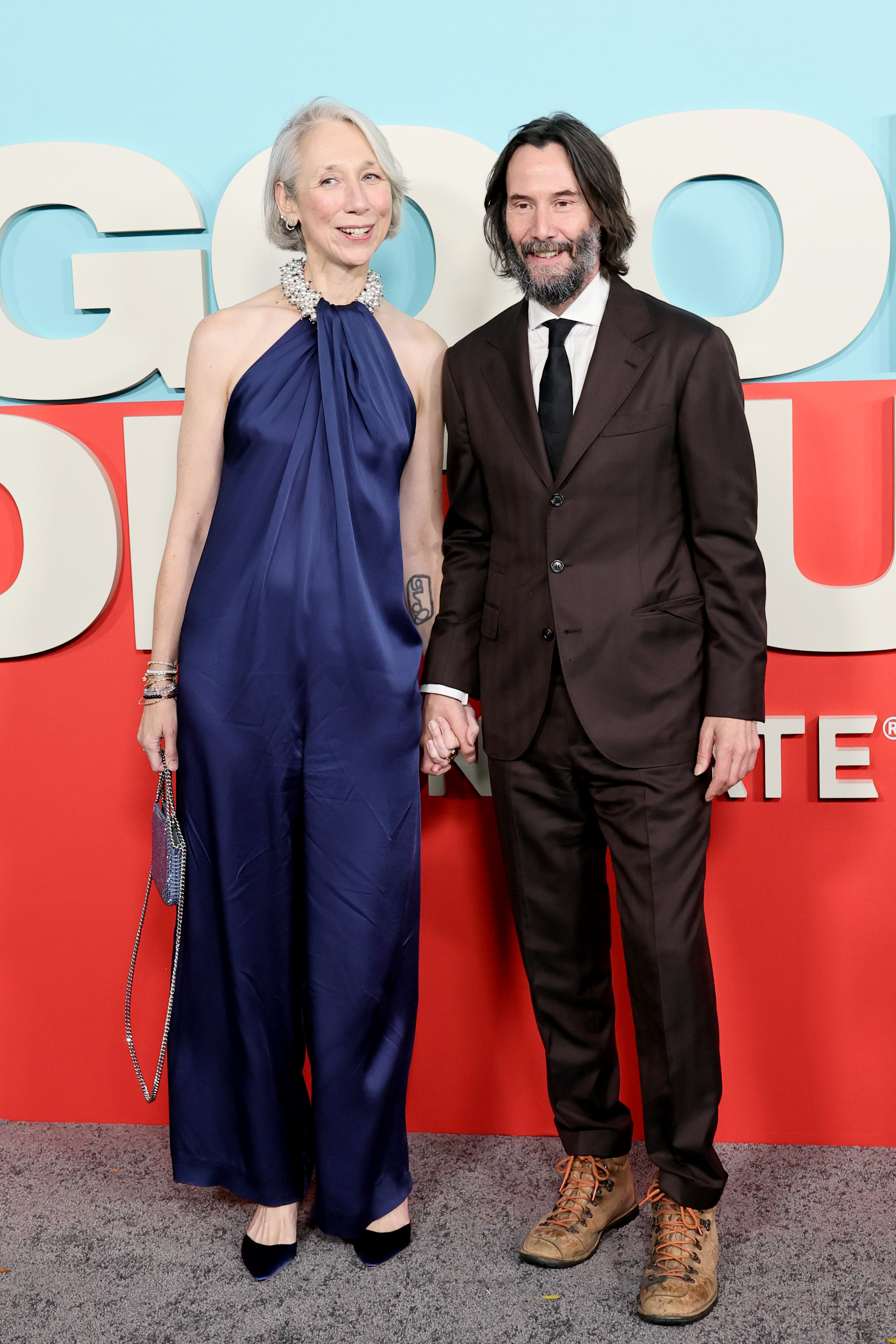 Alexandra Grant and Keanu Reeves smiling for the cameras. | Source: Getty Images