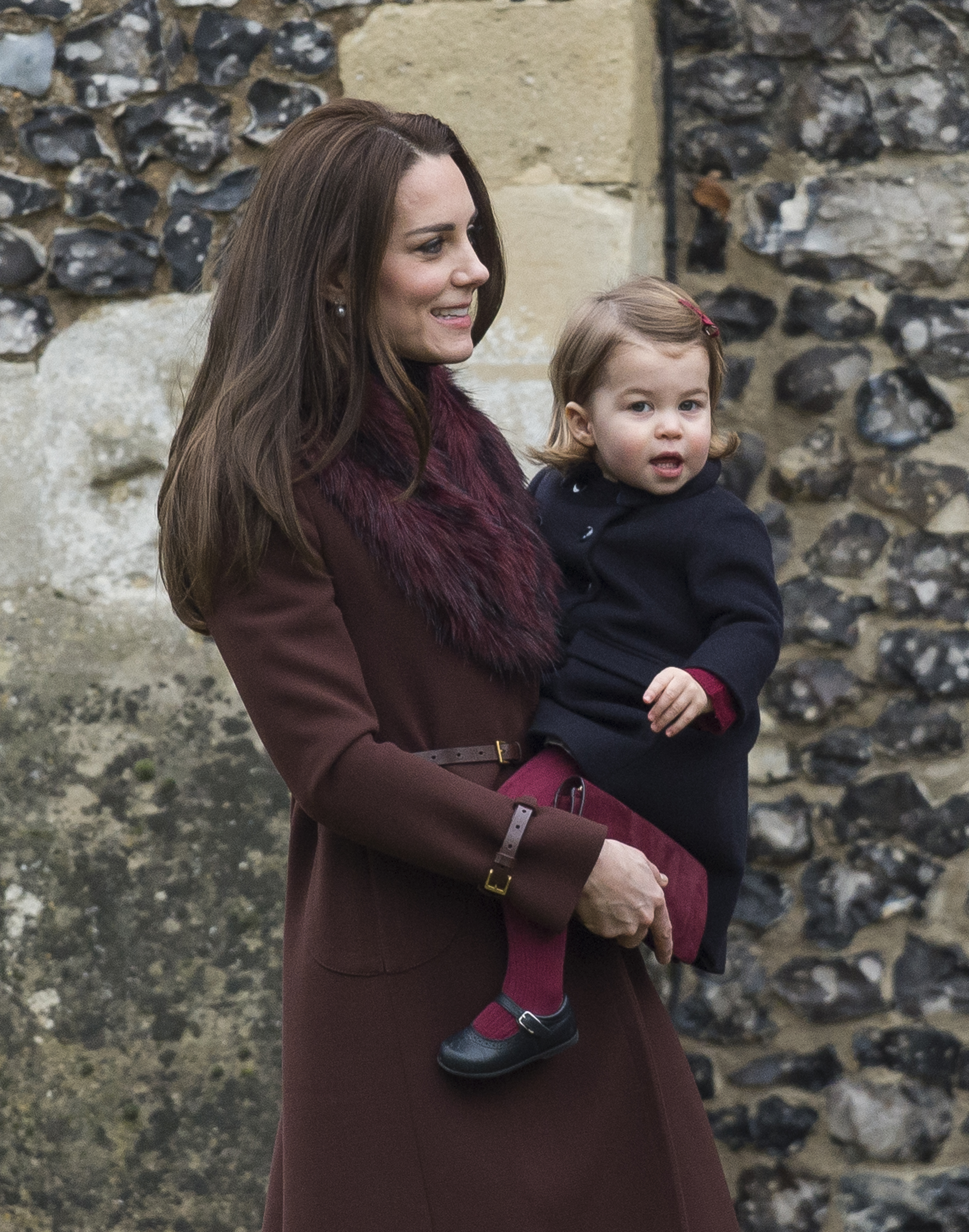 Catherine, Duchess of Cambridge, all smiles as she carried Princess Charlotte to Christmas Day service. The royal kept her look classic, wearing her brunette hair sleek and straight for the festive outing.