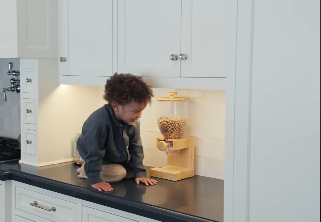 Three-year-old Leodis shows off his impressive climbing skills right on top of his mother's sleek kitchen counter. | Source: YouTube/@Archdigest