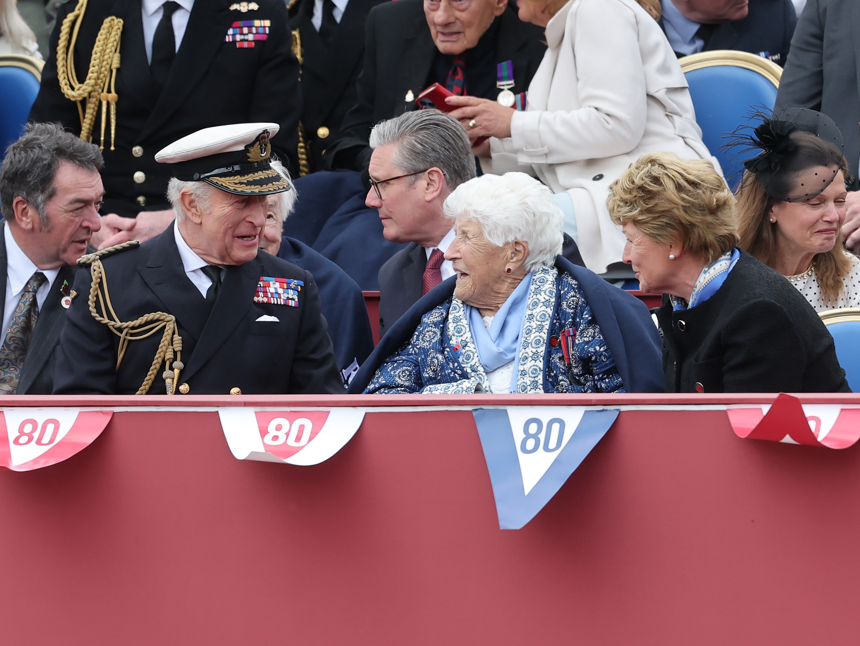 King Charles III, Britain's Prime Minister Keir Starmer, Veteran Joy Trew and Lady Sarah McCorquodale during the military procession to mark the 80th anniversary of VE Day in London, England on May 5, 2025 | Source: Getty Images