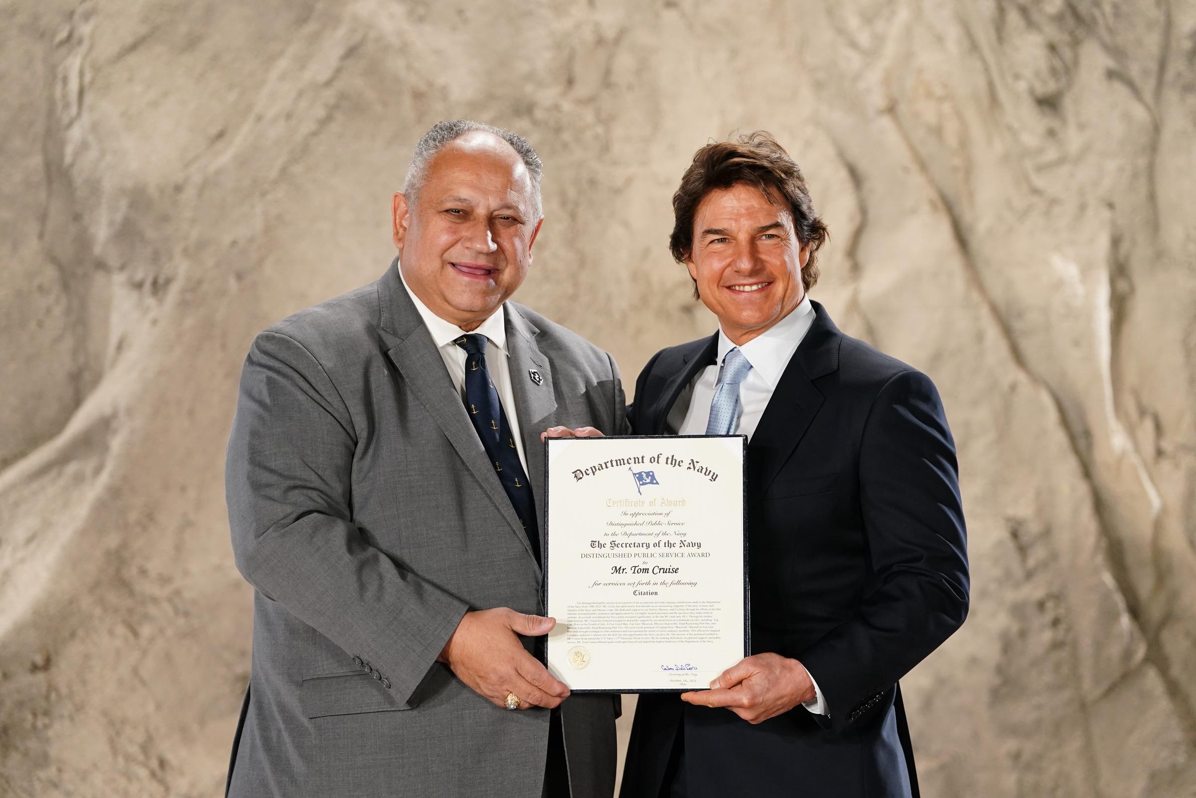 Tom Cruise and US Secretary of the Navy, Carlos Del Toro at Long Cross, United Kingdom on December 17, 2024 | Source: Getty Images