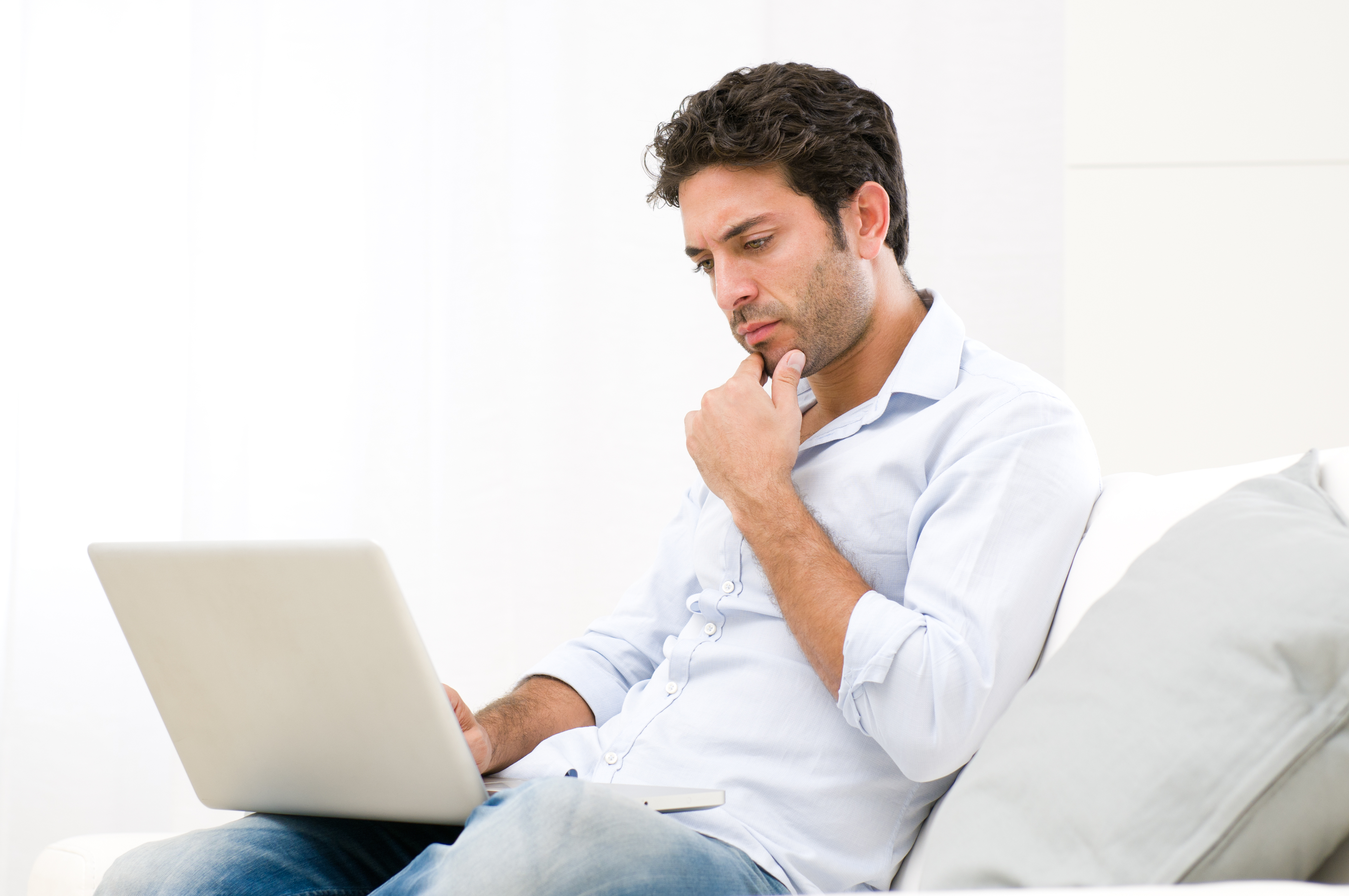 Man looking at his computer | Source: Shutterstock