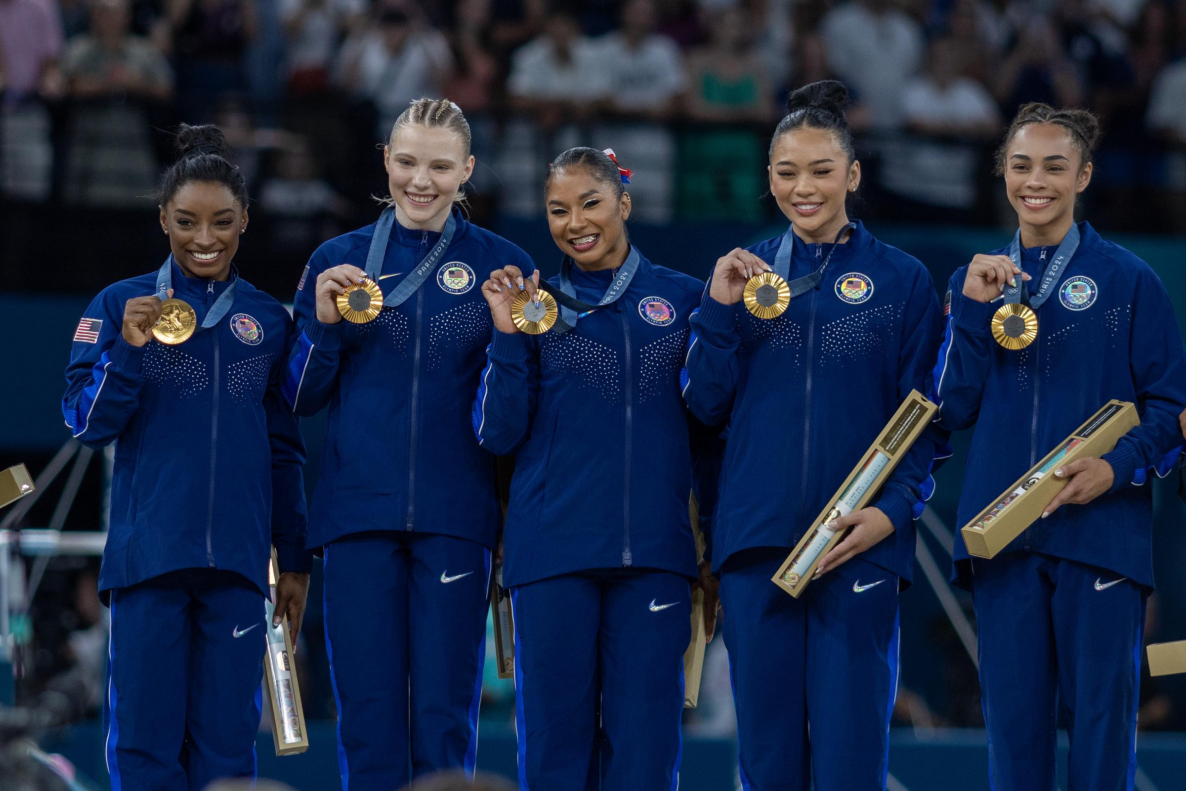 (L-R) Simone Biles, Jade Carey, Jordan Chiles, Sunisa Lee, and Hezly Rivera pose with their gold medals after the teams victory during the Artistic Gymnastics Team Final for Women on July 30, 2024 in Paris, France. | Source: Getty Images