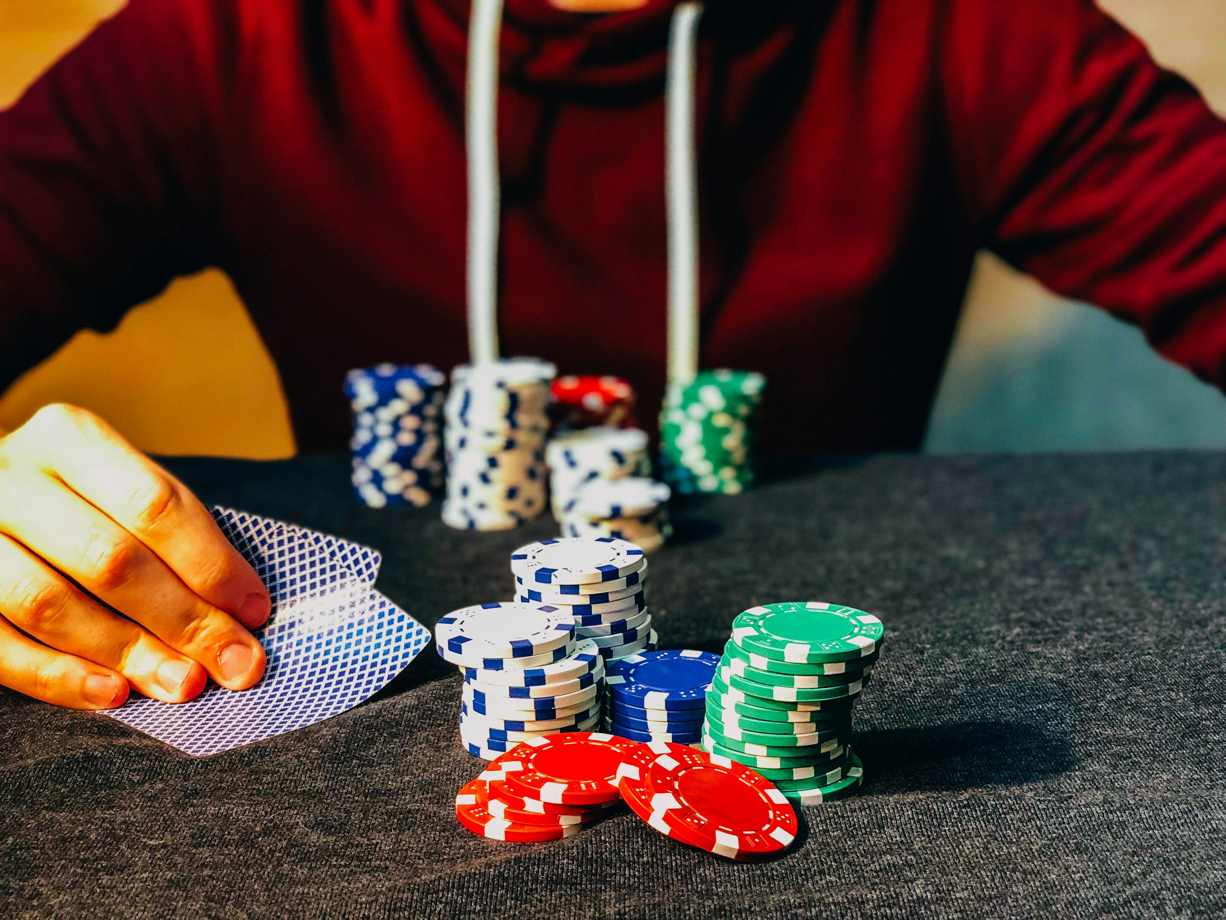 A man in a casino, sitting with poker chips | Source: Unsplash