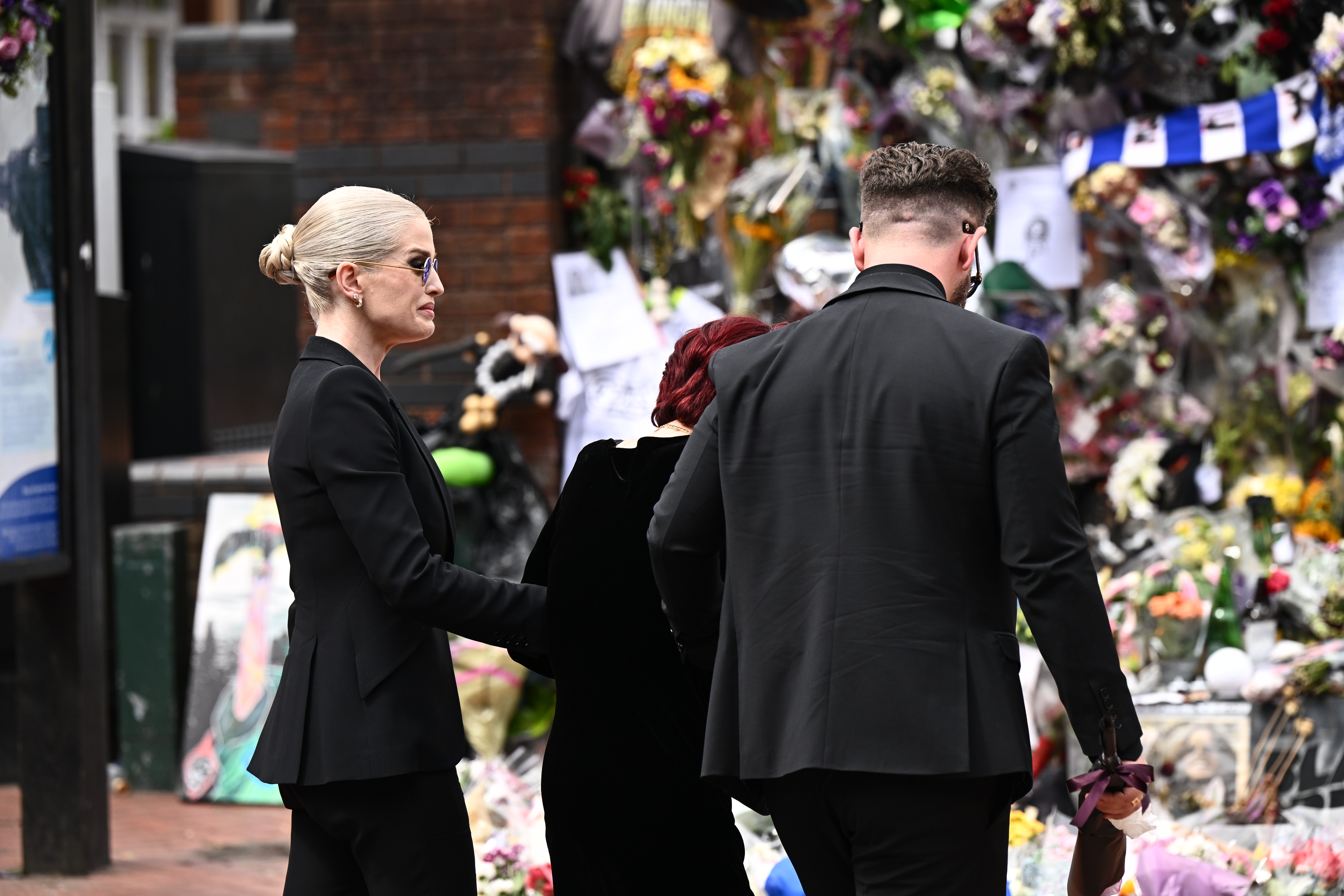Kelly, Sharon, and Jack Osbourne arrive to view tributes to the late Ozzy Osbourne from fans in Birmingham, England on July 30, 2025 | Source: Getty Images