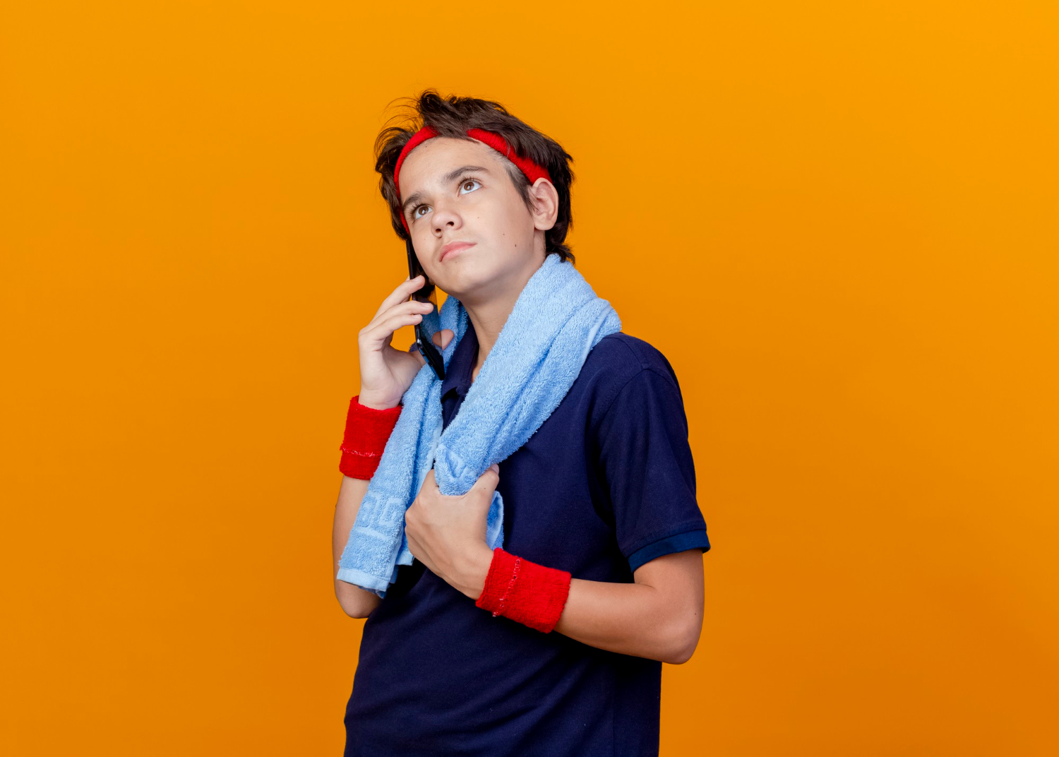 A young boy talking on the phone | Source: Freepik