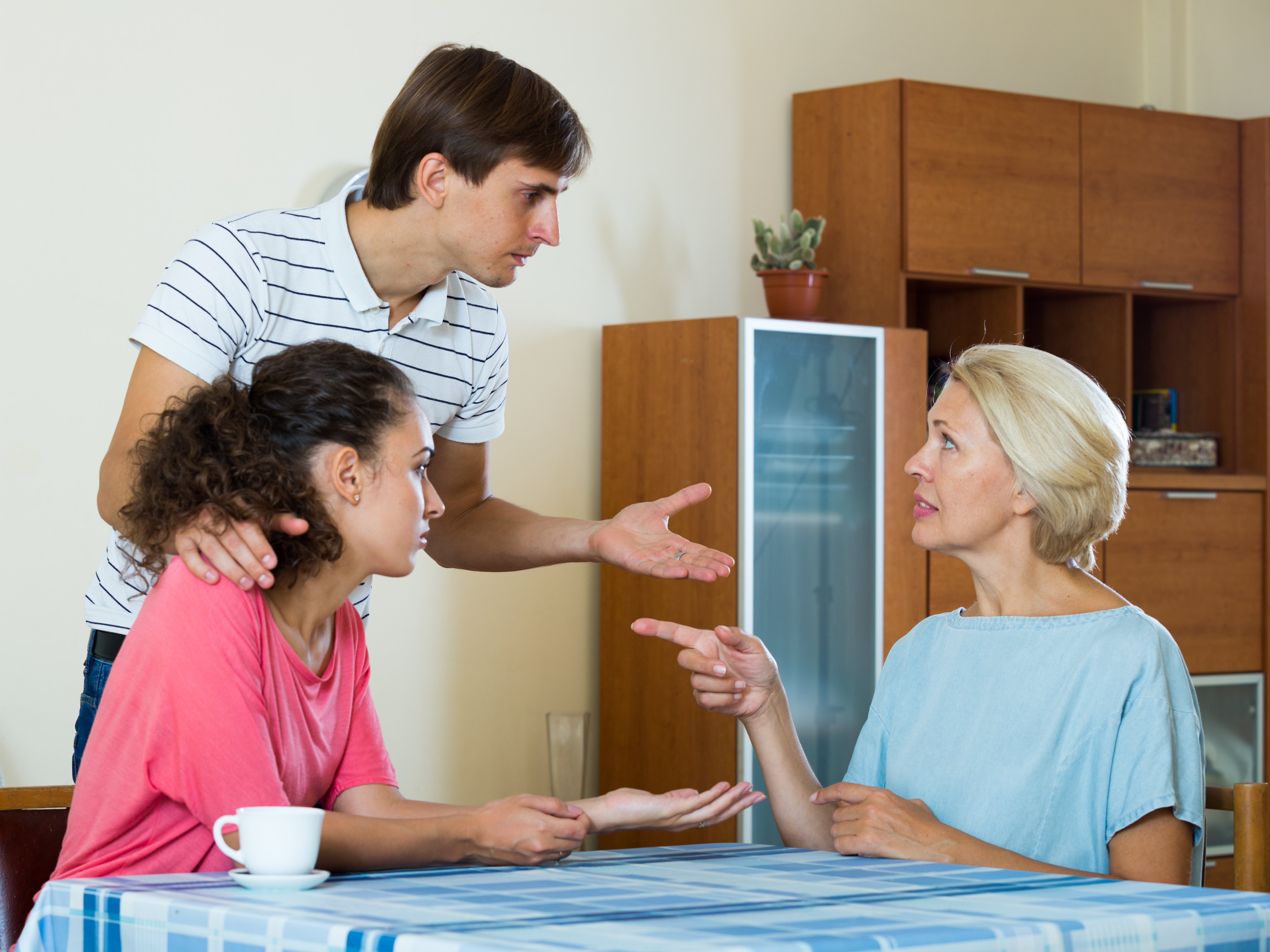A young couple is seen having a serious discussion with their mother | Source: Shutterstock