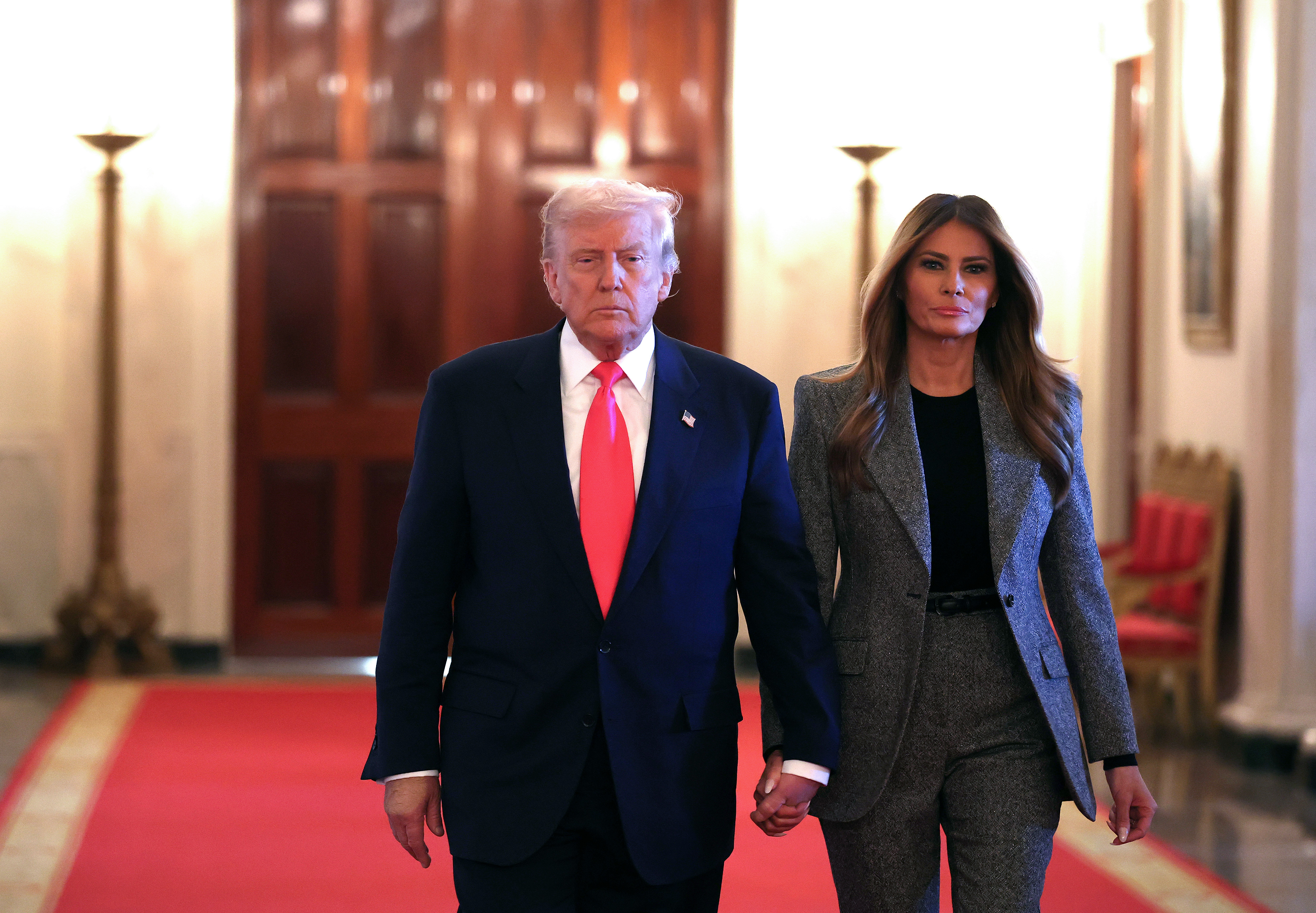 President Donald Trump and first lady Melania Trump arrive for the signing ceremony for the "Fostering the Future" executive order in the East Room of the White House on November 13, 2025 | Source: Getty Images