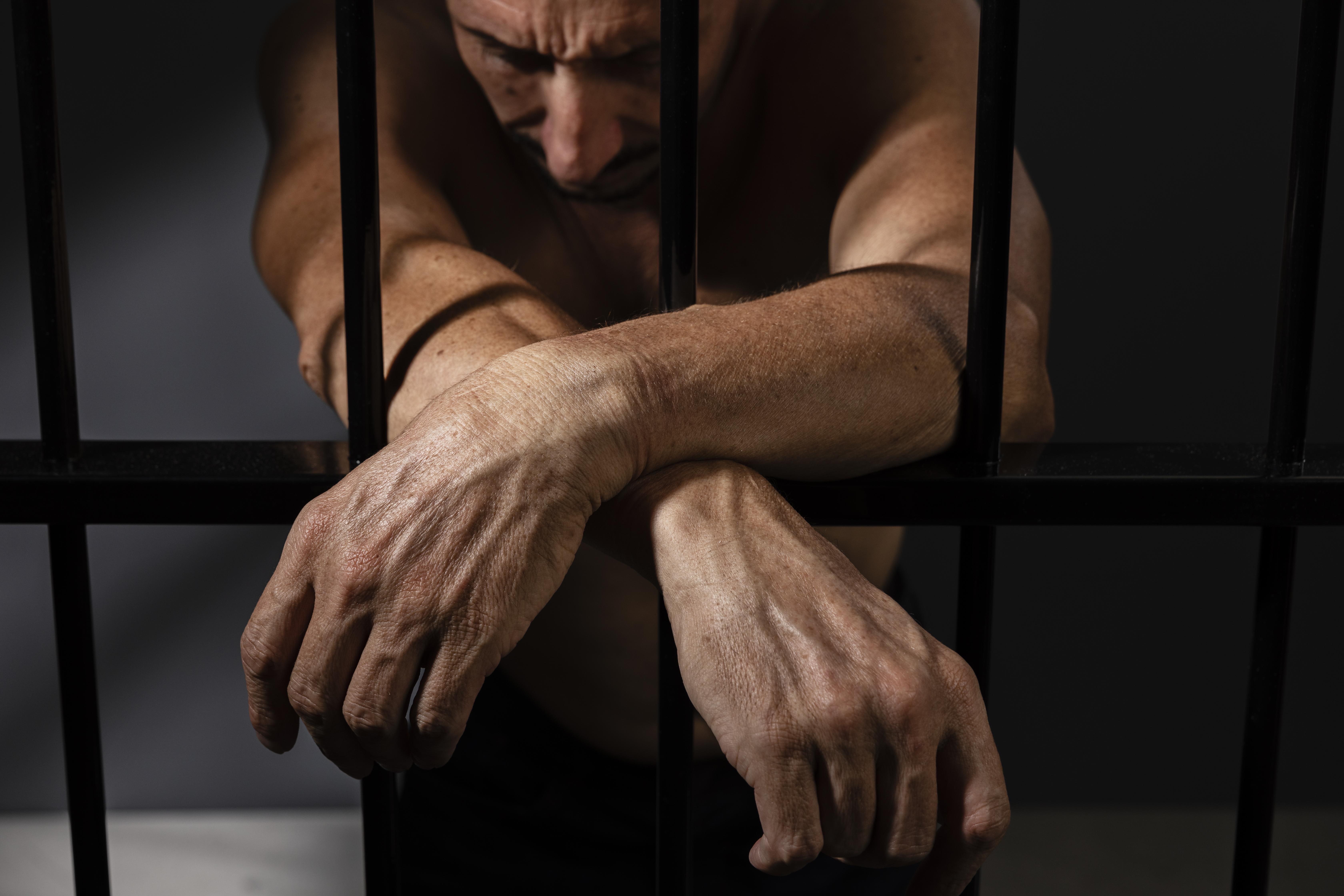 A man behind bars | Source: Freepik