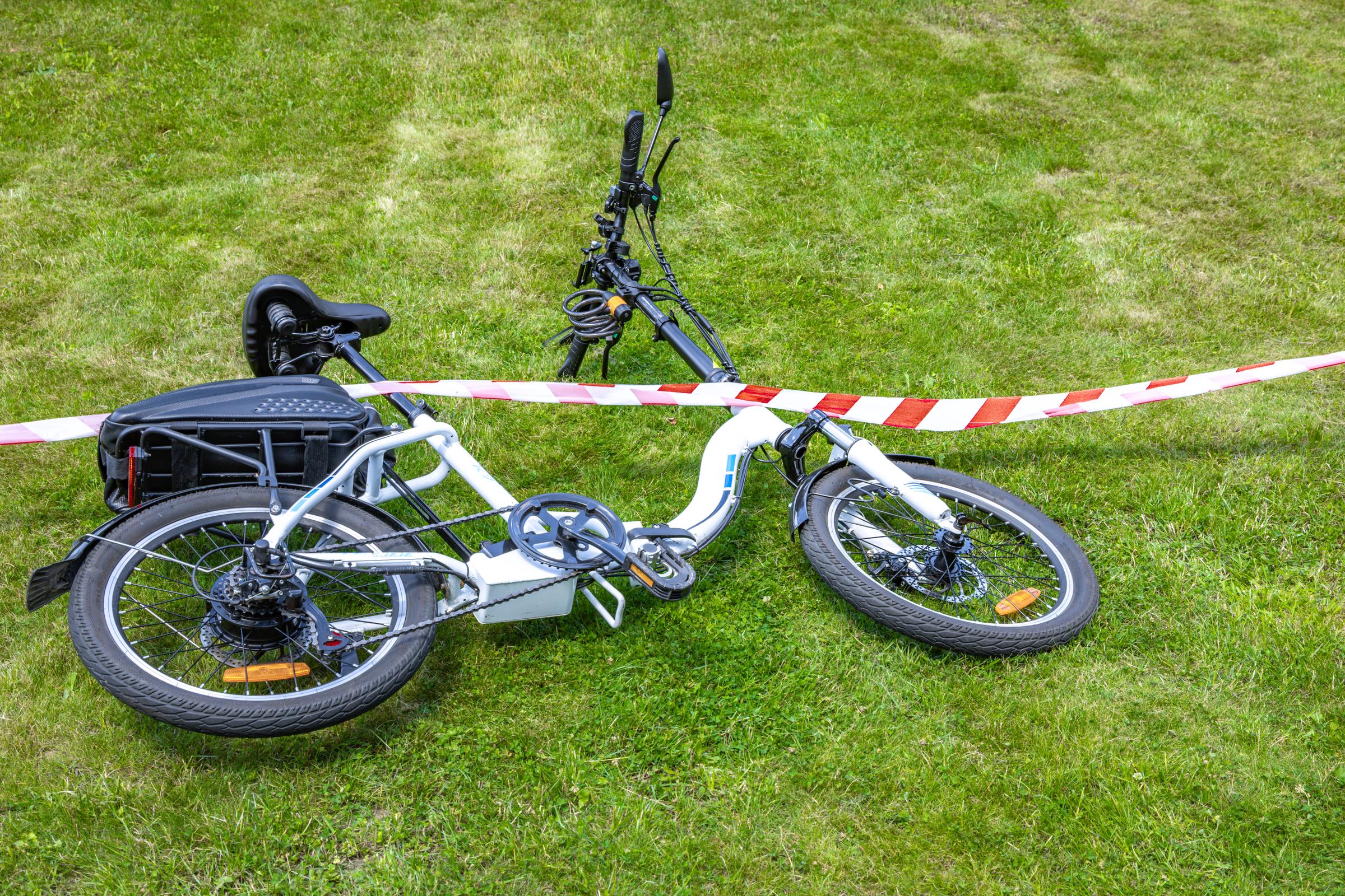 The scene of a bicycle accident surrounded by red and white warning tape. | Source: Getty Images
