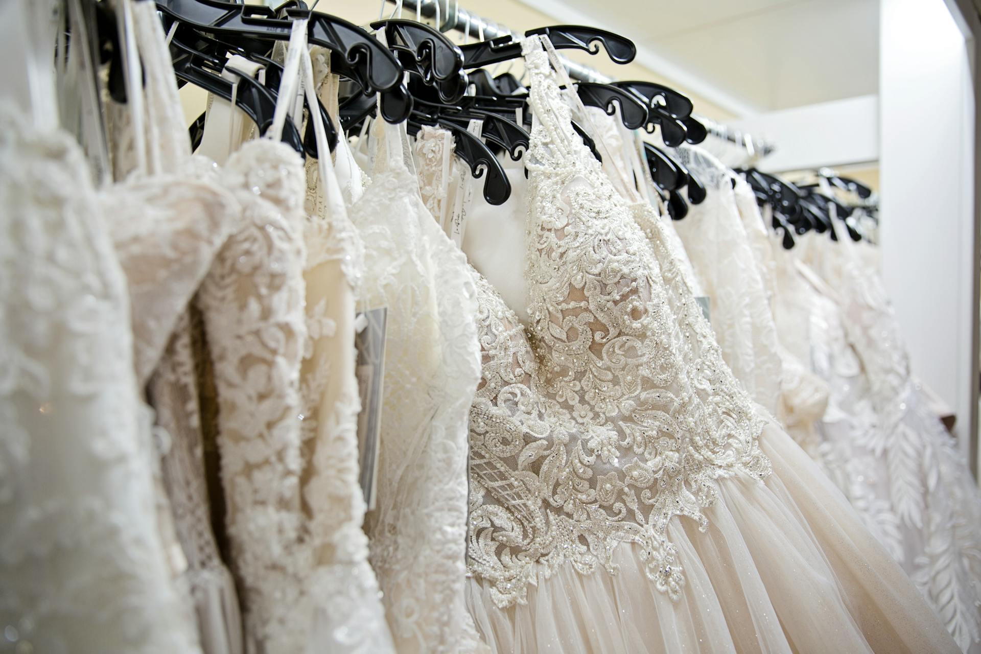 White gowns on a rack | Source: Pexels