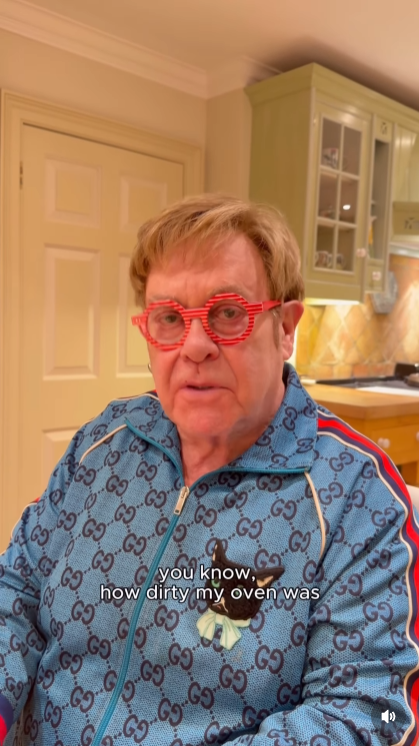 Doubling down with a straight face and red-striped specs, John insists he's "not a dirty person" — and promises he can prove it, setting fans up for a gloriously over-the-top cleaning demonstration. | Source: Instagram/eltonjohn