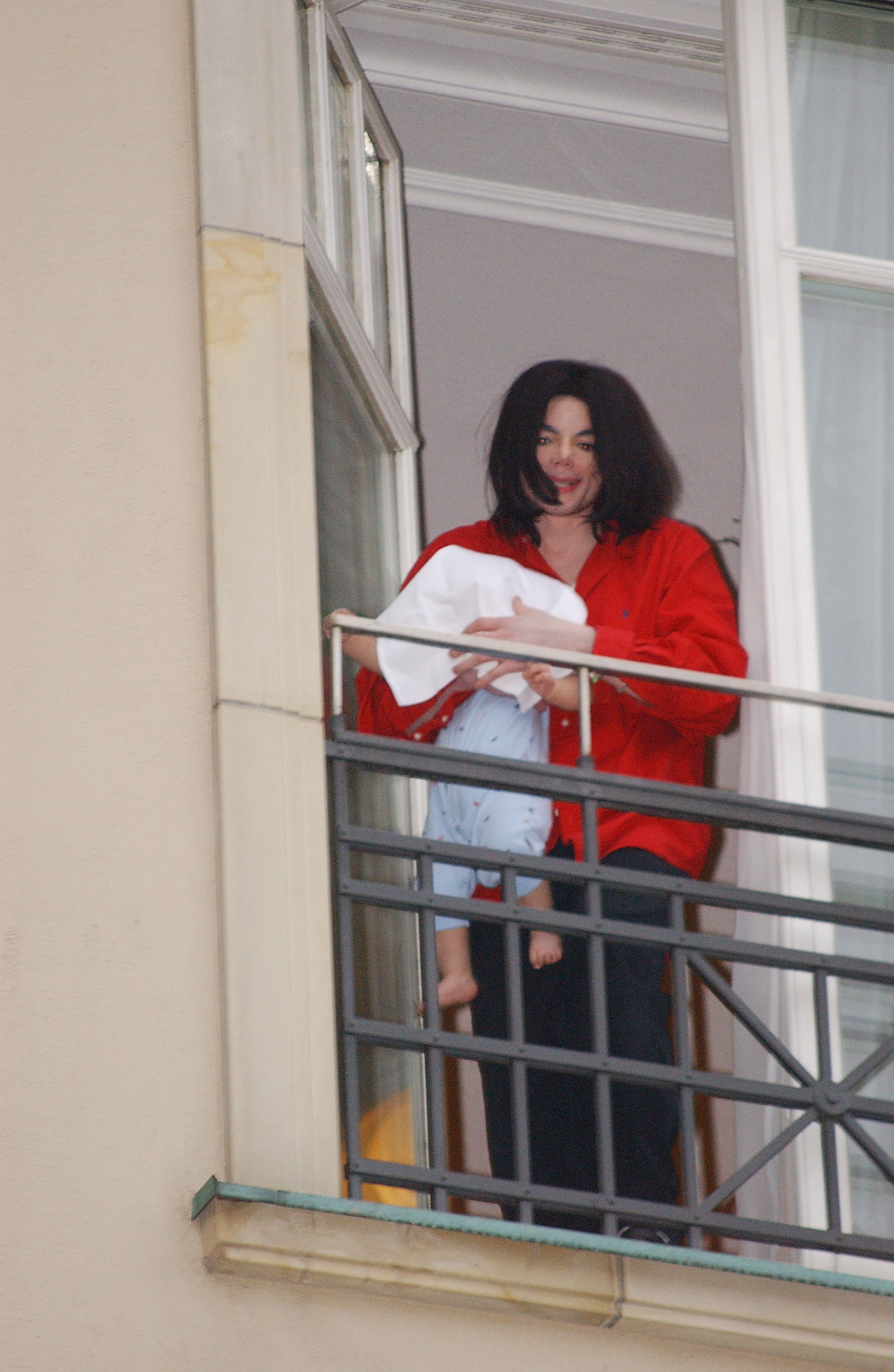 Michael Jackson holds his months-old son, Prince Michael II, on the balcony of the Adlon Hotel on November 19, 2002, in Berlin, Germany | Source: Getty Images
