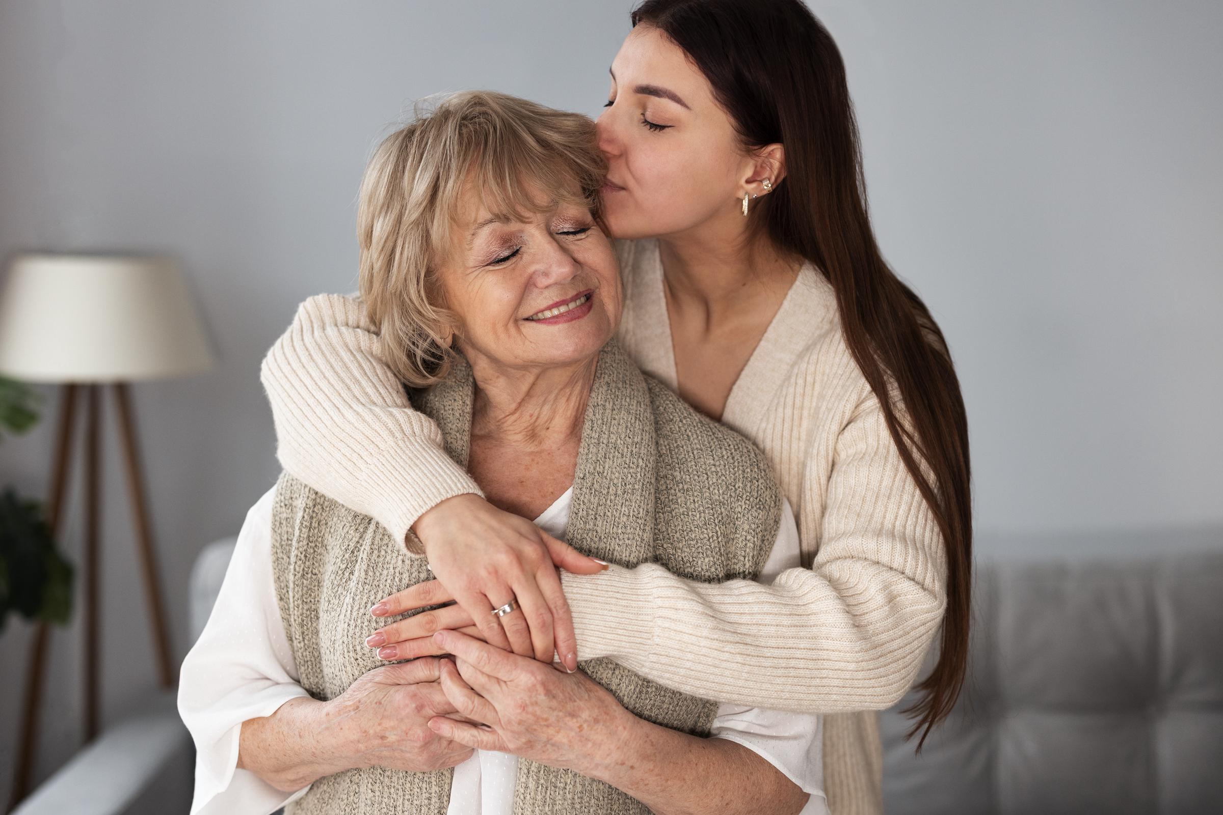 A young woman and an older woman sharing a hug | Source: Freepik