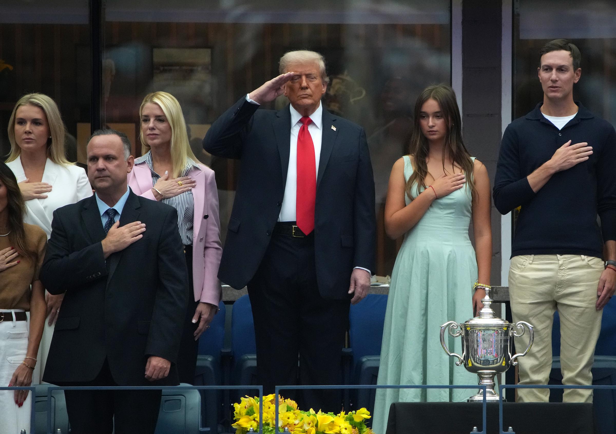 President Donald Trump, Arabella Kushner, White House Press Secretary Karoline Leavitt, U.S Attorney General Pam Bondi, and other members of the president's circle listen to the singing of the National Anthem at the U.S. Open men's singles final at the Billie Jean King National Tennis Center in New York City on September 7, 2025 | Source: Getty Images