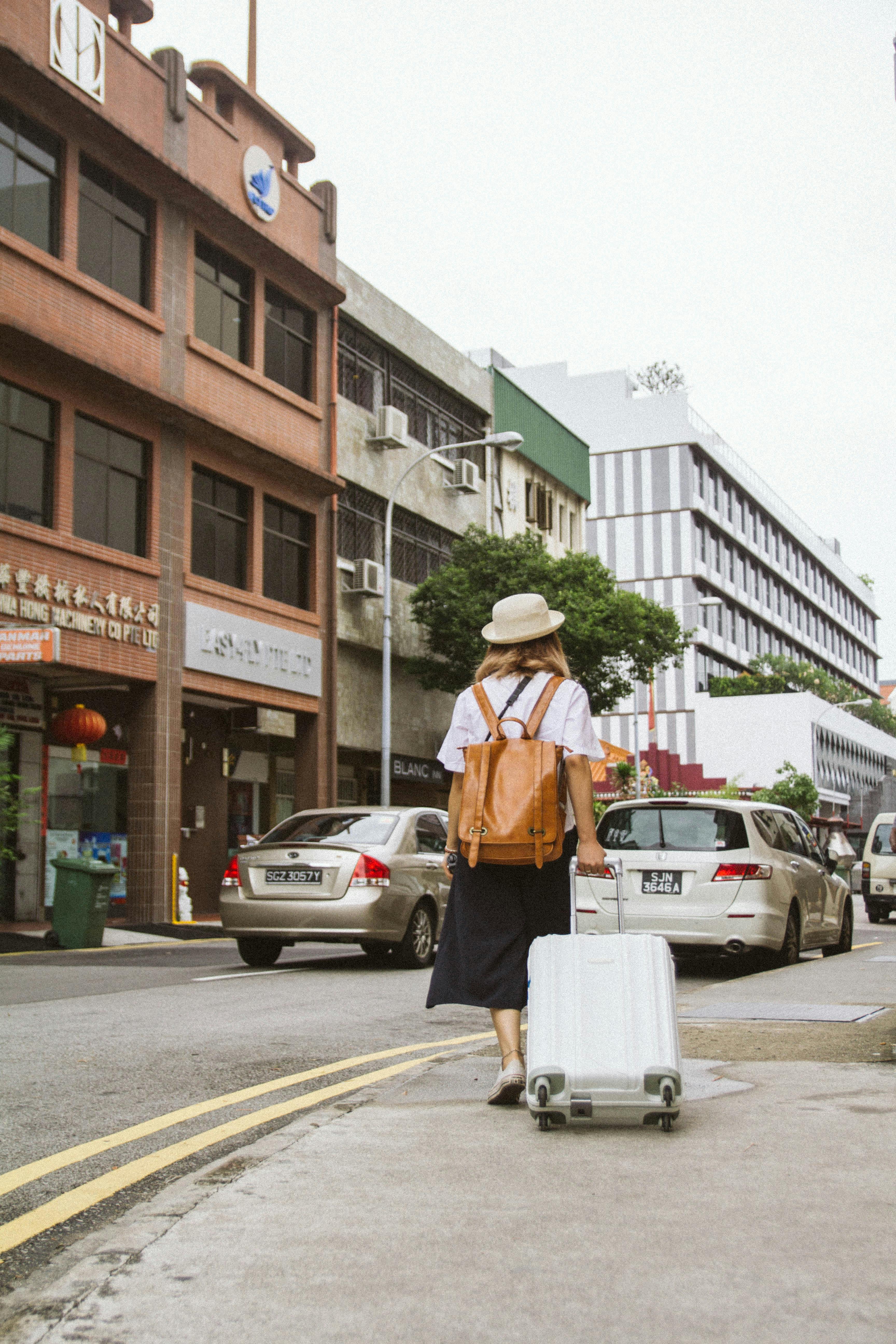 A woman walking away pulling luggage | Source: Pexels