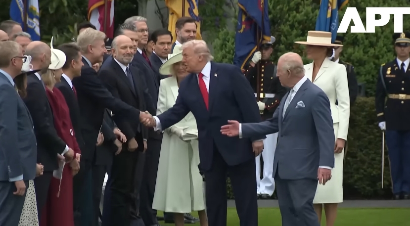 The president continues along the line, exchanging handshakes with several officials in succession, as King Charles III looks back toward the interaction and Queen Camilla remains positioned behind, ready to proceed. | Source: YouTube/APT