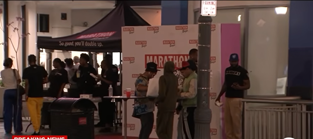 Guests line up inside the newly opened Marathon Burger during its grand opening event in Long Beach | Source: YouTube/@ABC7