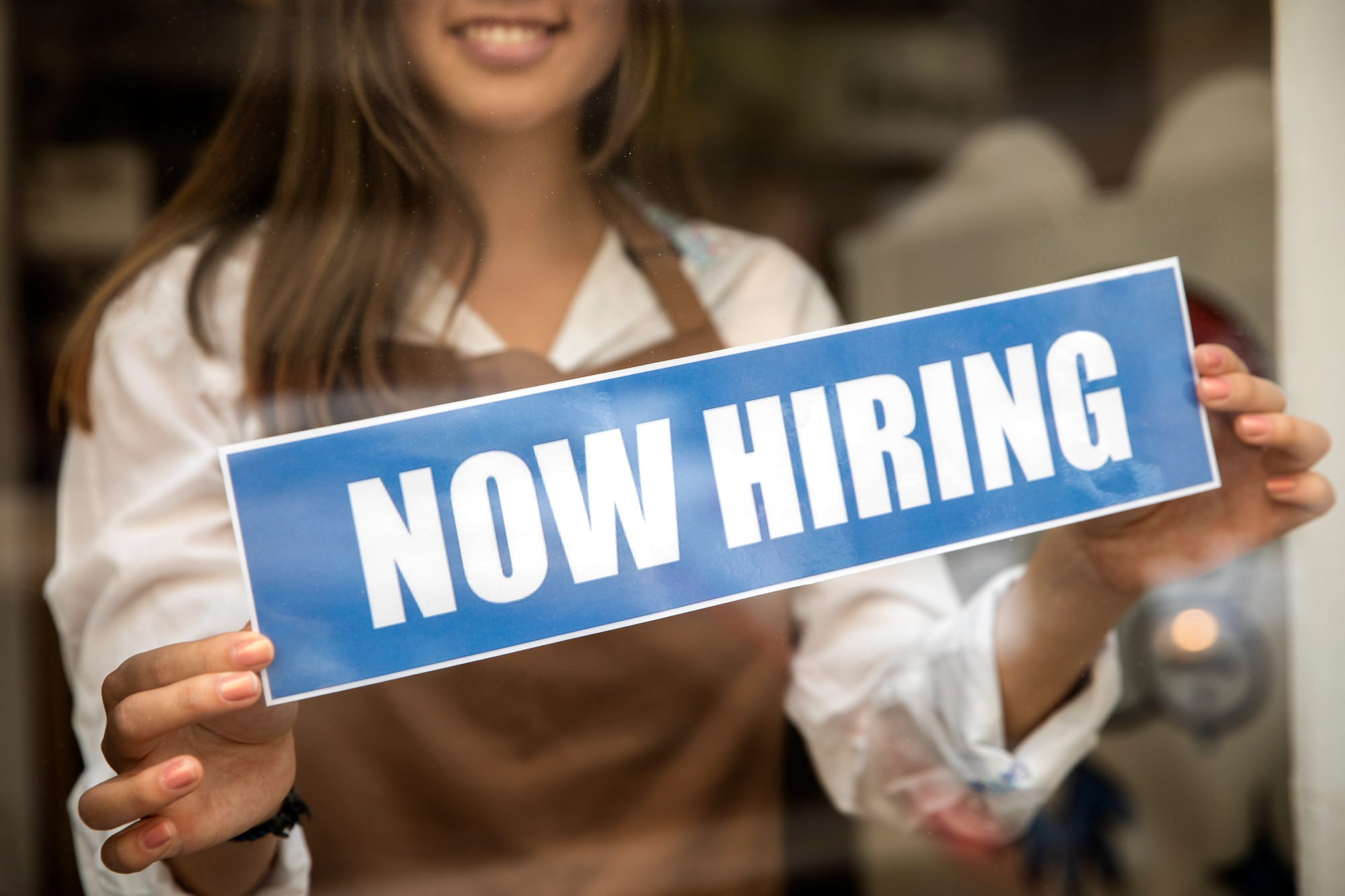 A store assistant sticking a 