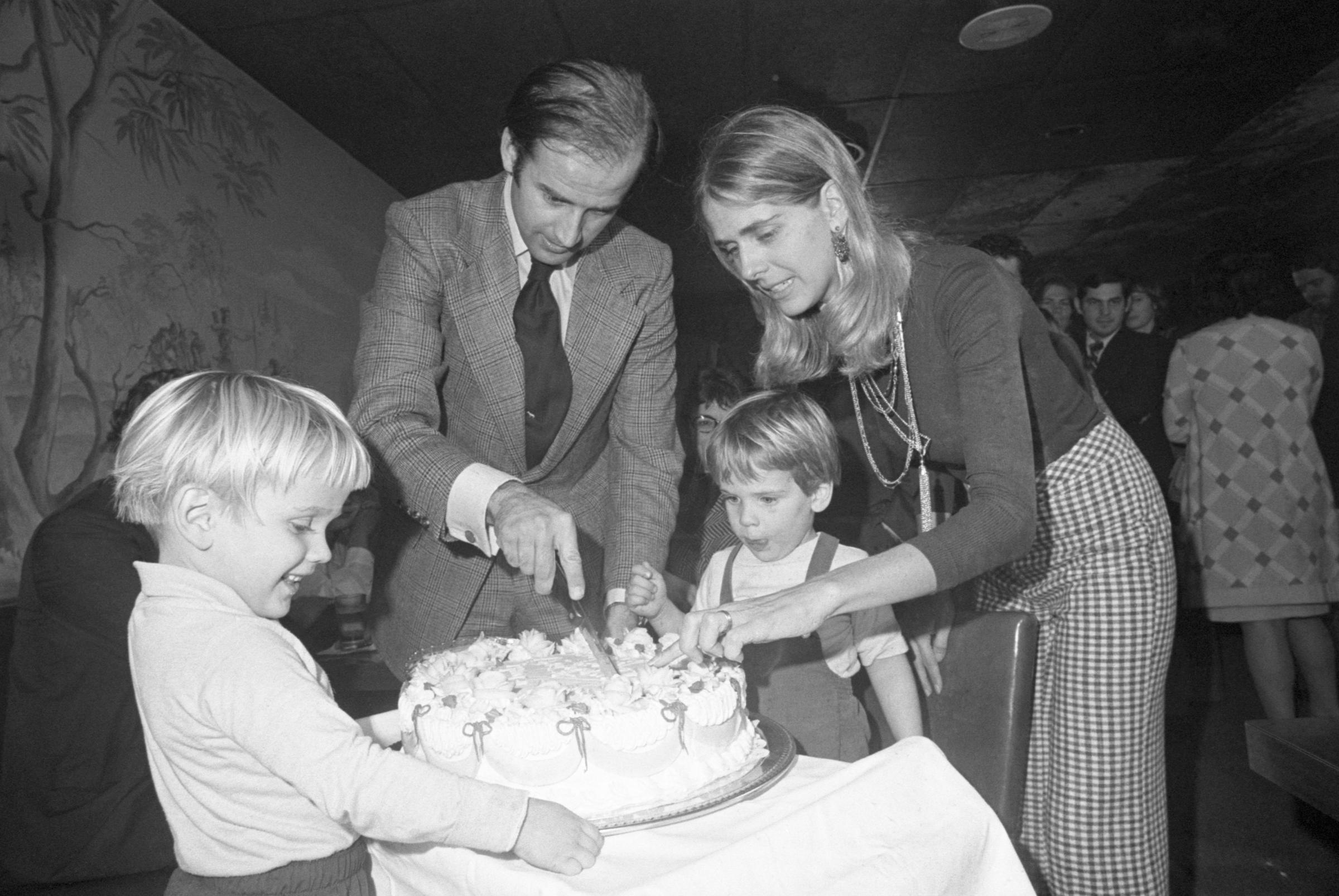 Senator-elect Joe Biden and Nelia Biden cut his 30th birthday cake at a party in Wilmington, on November 20, 1972, with their son, Hunter, and another child | Source: Getty Images