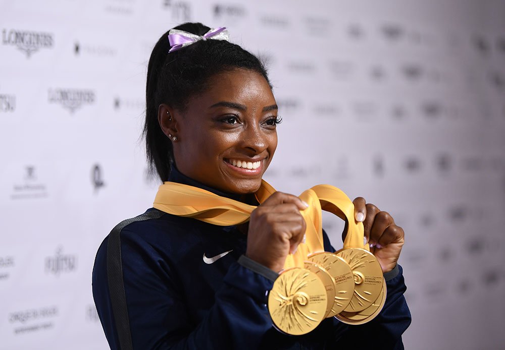 Simone Biles of The United States poses for photos with her multiple gold medals during day 10 of the 49th FIG Artistic Gymnastics World Championships at Hanns-Martin-Schleyer-Halle on October 13, 2019 in Stuttgart, Germany. I Image: Getty Images.