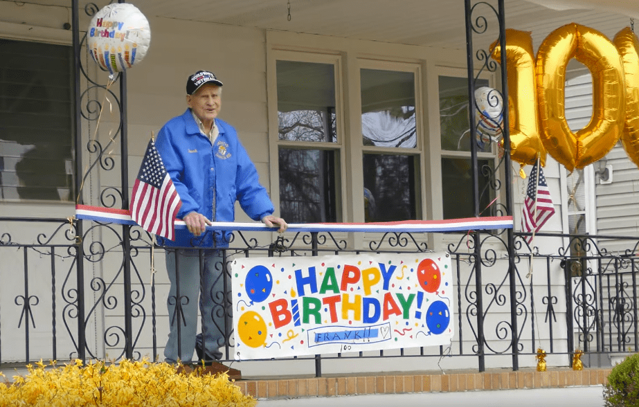 World War II veteran Frank J. Uveges watching his birthday parade from his front porch. | Photo: YouTube/NJ.com