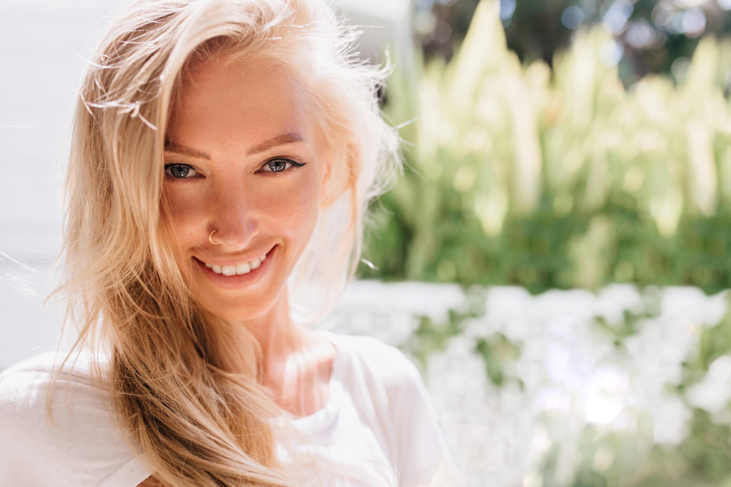 A smiling blonde woman | Source: Freepik