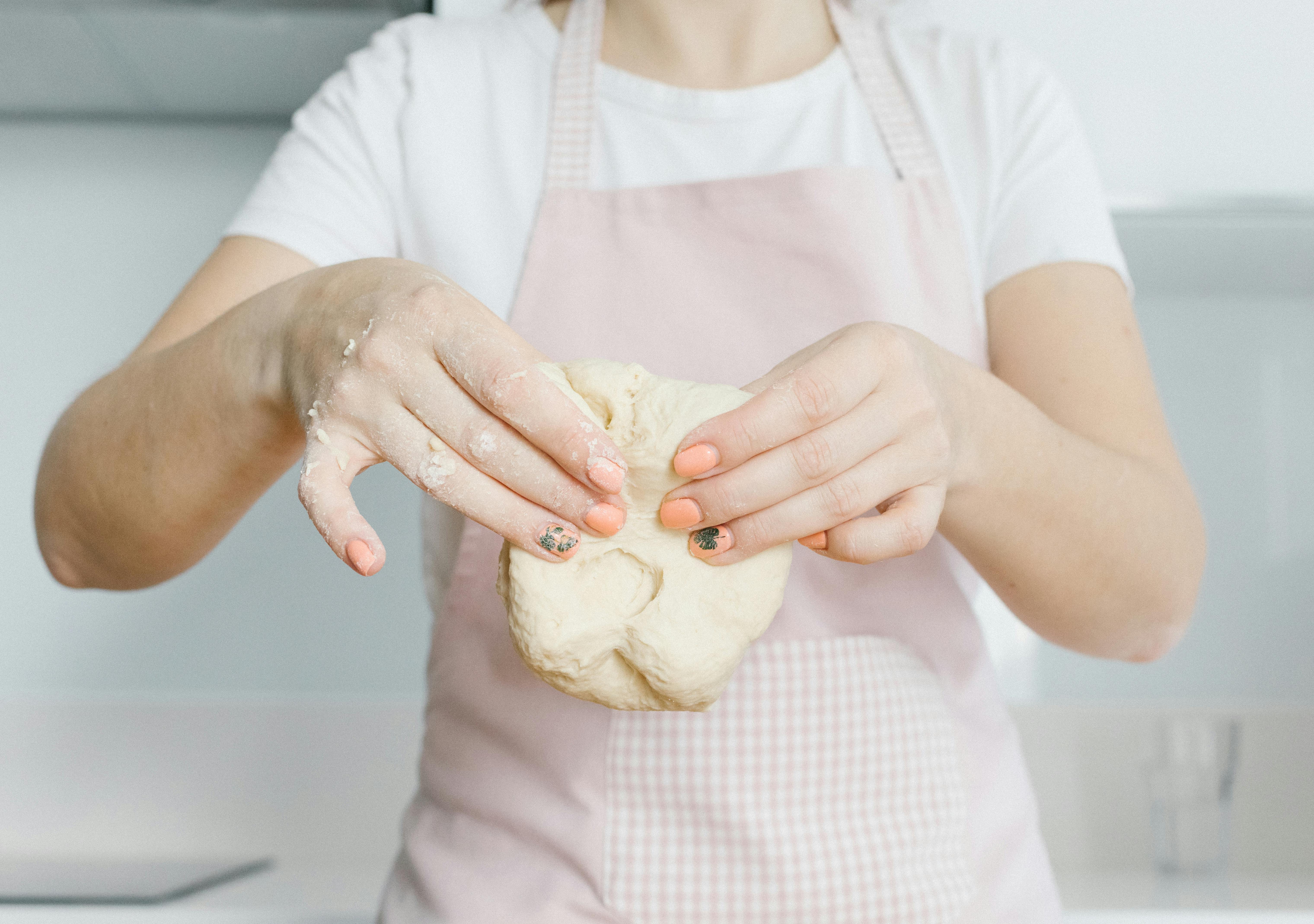 A woman holding dough | Source: Pexels