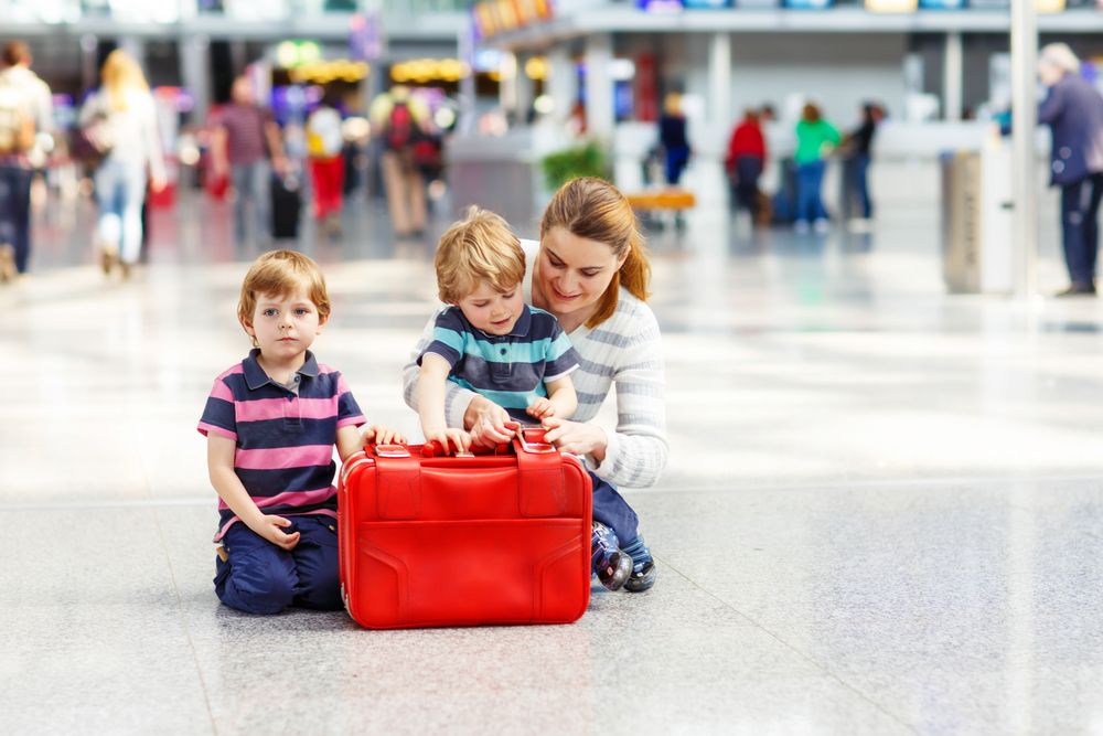 A mother takes care of her kids at the airport. | Source: Shutterstock