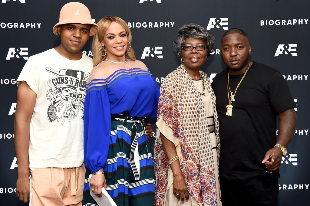Faith Evans with her son with the Notorious B.I.G., CJ Wallace and his mother, Voletta Wallace, and entourage member,  Lil' Cease at the screening of A&E's "Biography Presents: Biggie: The Life of Notorious B.I.G." in August 2017. | Photo: Getty Images