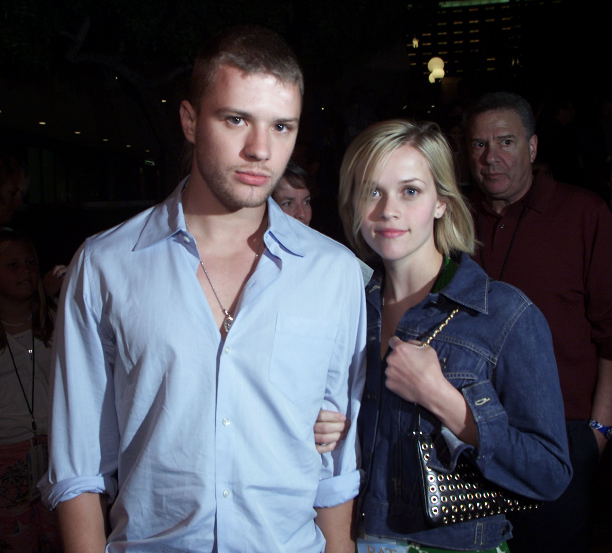 Witherspoon and Phillippe attend the premiere of "Rat Race" at the Cineplex Odeon Century Plaza in Los Angeles, California, on July 30, 2001. Witherspoon rests her hands on Phillippe’s arms as they stand close together, both looking directly at the camera.