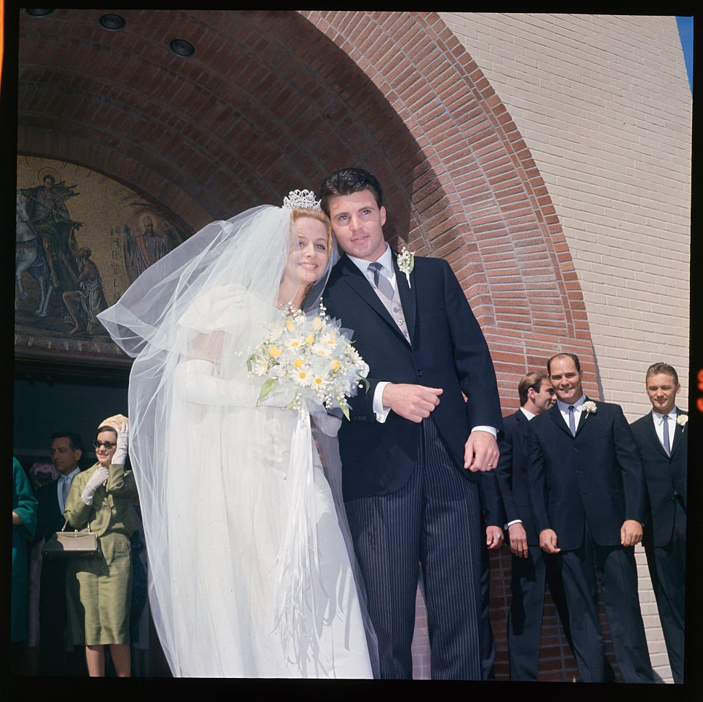 Teenage idol rick Nelson, 22, and Kris Harmon, 18, after their wedding at the St. Martin of Tours Church in Brentwood in 1963 | Source: Getty Images