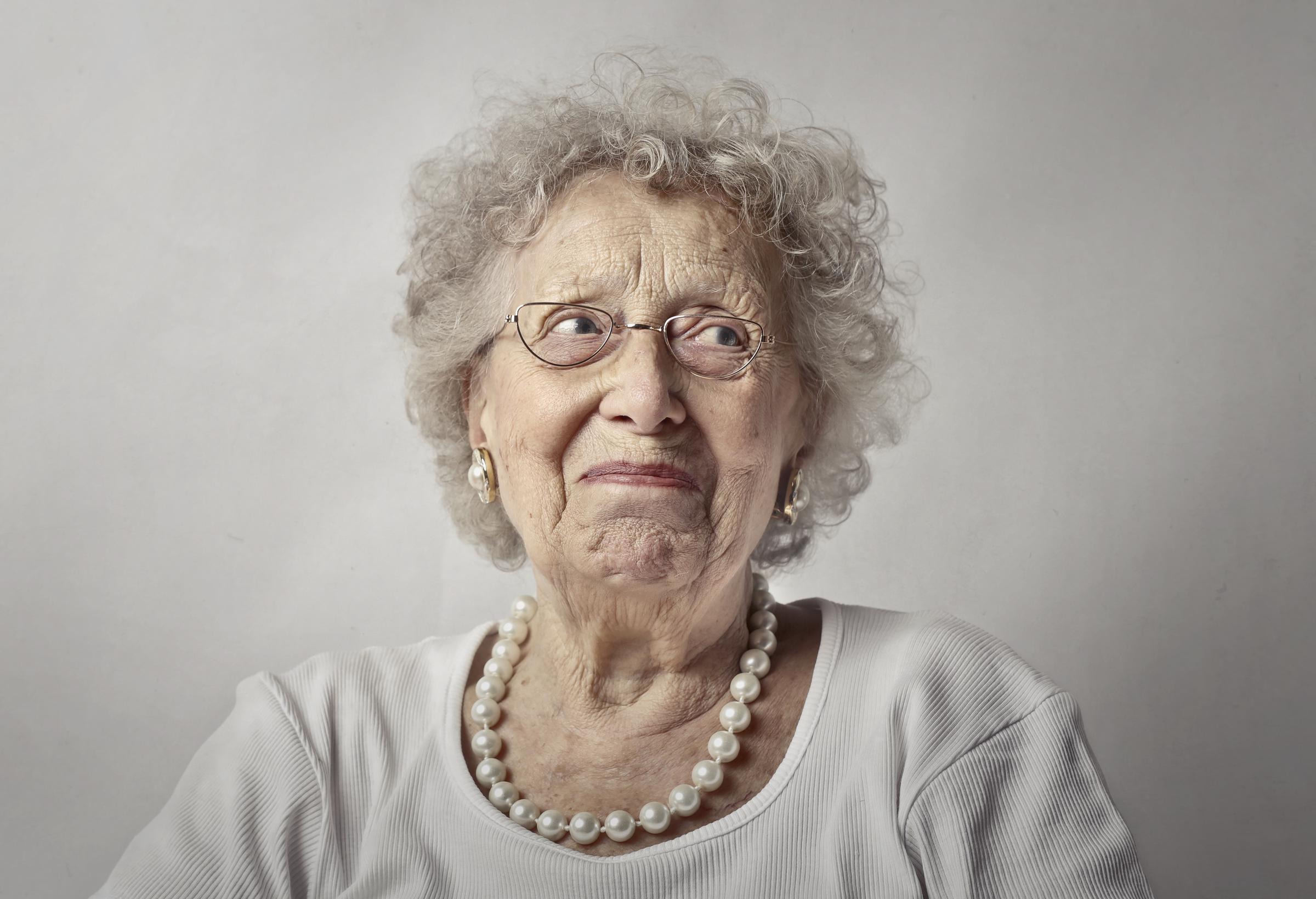 A sad elderly woman | Source: Freepik